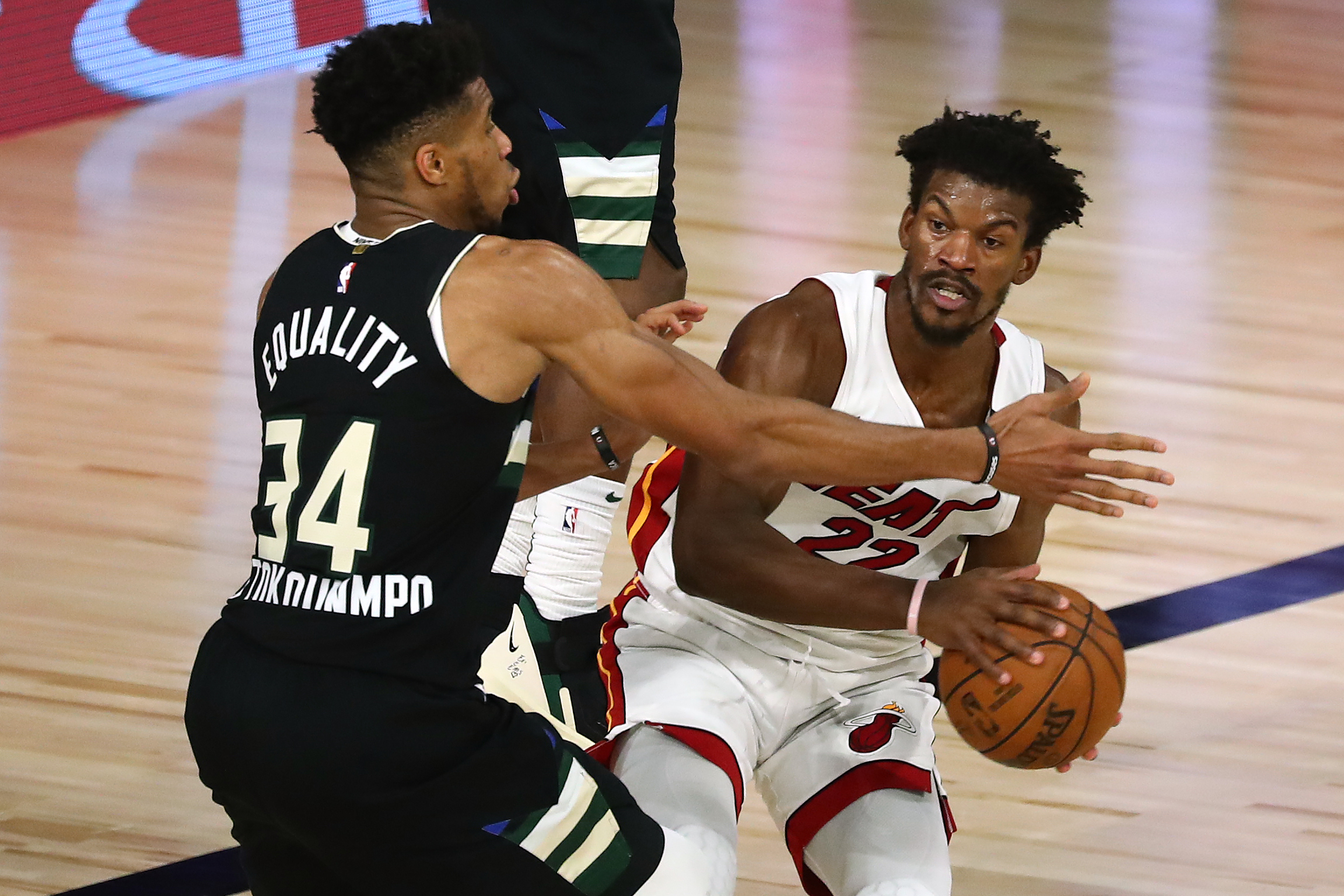 Sep 2, 2020; Lake Buena Vista, Florida, USA; Milwaukee Bucks forward Giannis Antetokounmpo (34) pressures Miami Heat forward Jimmy Butler (22) during the second half of game two of the second round of the 2020 Stanley Cup Playoffs at The Field House. Mandatory Credit: Kim Klement-USA TODAY Sports