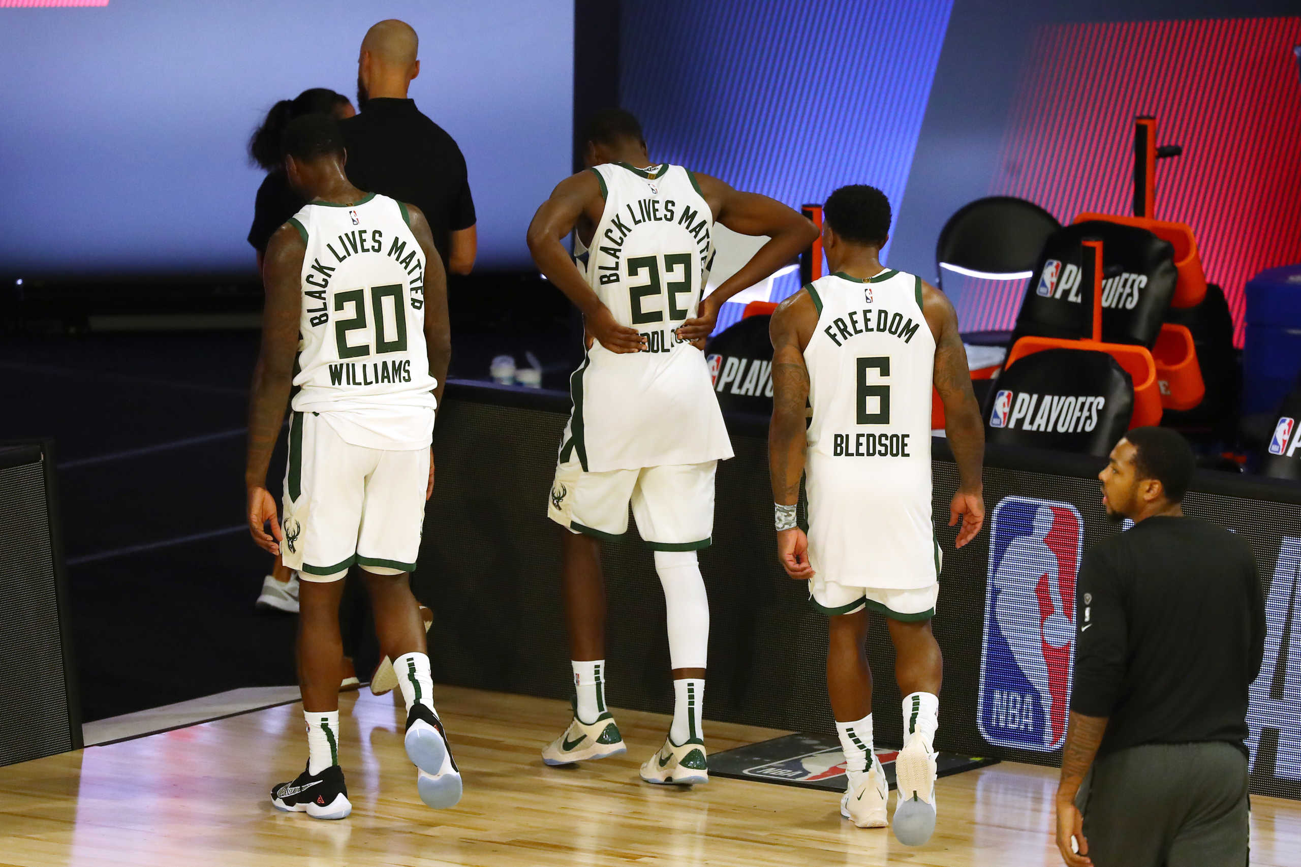 Sep 8, 2020; Lake Buena Vista, Florida, USA; Milwaukee Bucks forward Marvin Williams (20) and forward Khris Middleton (22) and guard Eric Bledsoe (6) leave the court after losing to the Miami Heat in game five in the second round of the 2020 NBA Playoffs at ESPN Wide World of Sports Complex. Mandatory Credit: Kim Klement-USA TODAY Sports