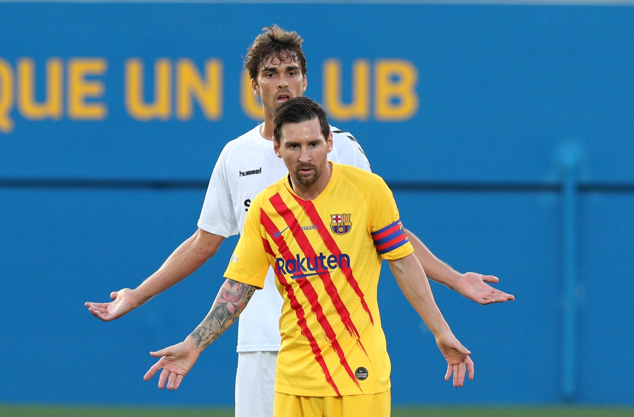 Soccer Football - Pre Season Friendly - FC Barcelona v Gimnastic Tarragona - Johan Cruyff Stadium, Barcelona, Spain - September 12, 2020 FC Barcelona's Lionel Messi with Gimnastic Tarragona's Javier Ribelles Alfonso during the match REUTERS