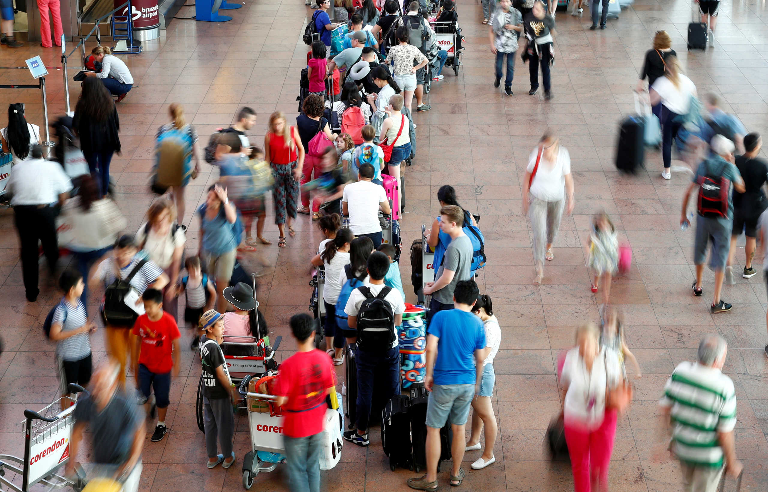 FILE PHOTO: Passengers queue inside the departure hall at Zaventem International Airport near Brussels, Belgium July 27, 2018. REUTERS