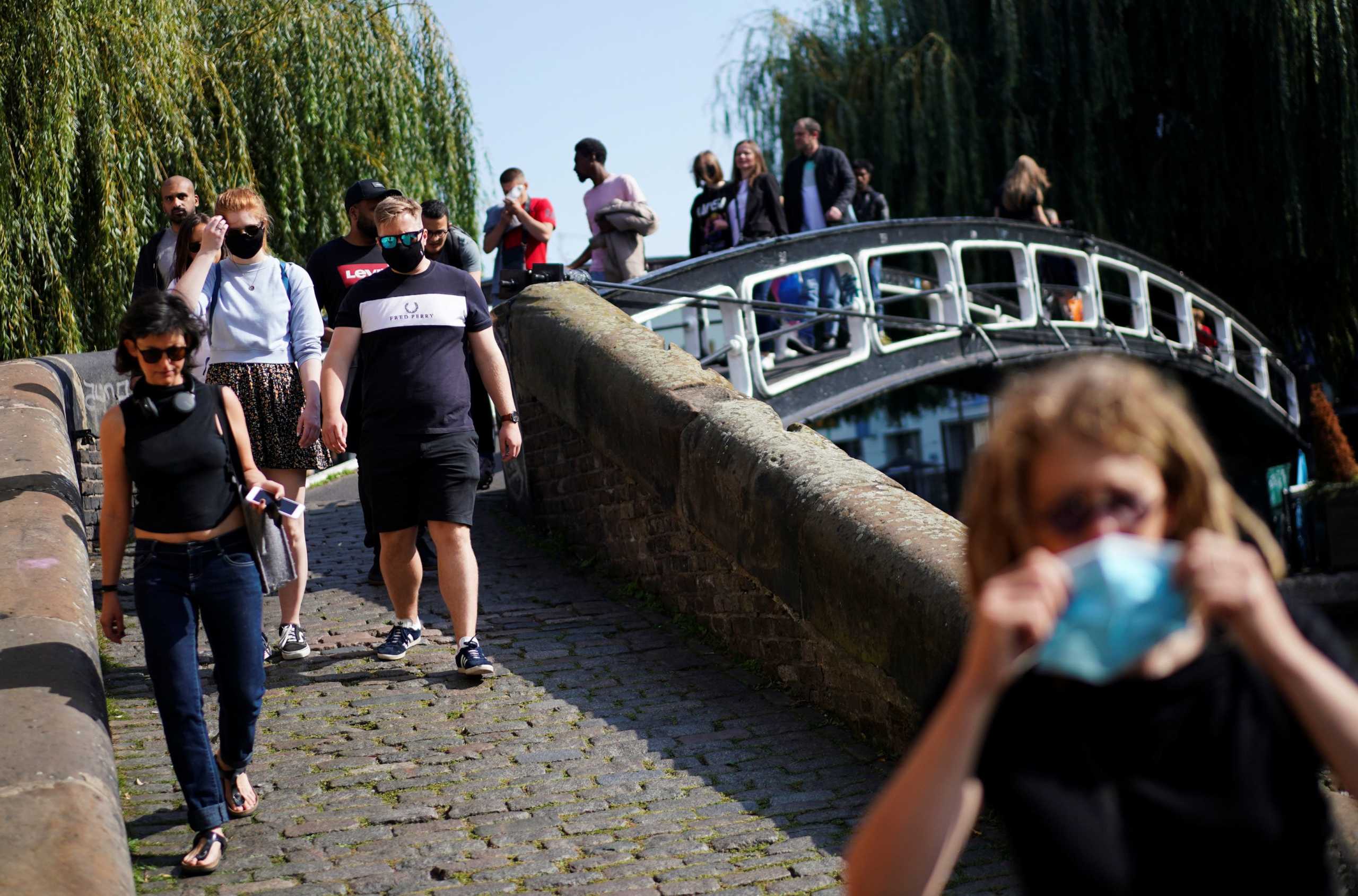 People walk along the bank of Regents Canal, amid the coronavirus disease (COVID-19) outbreak, in Camden, London, Britain, September 19, 2020. REUTERS