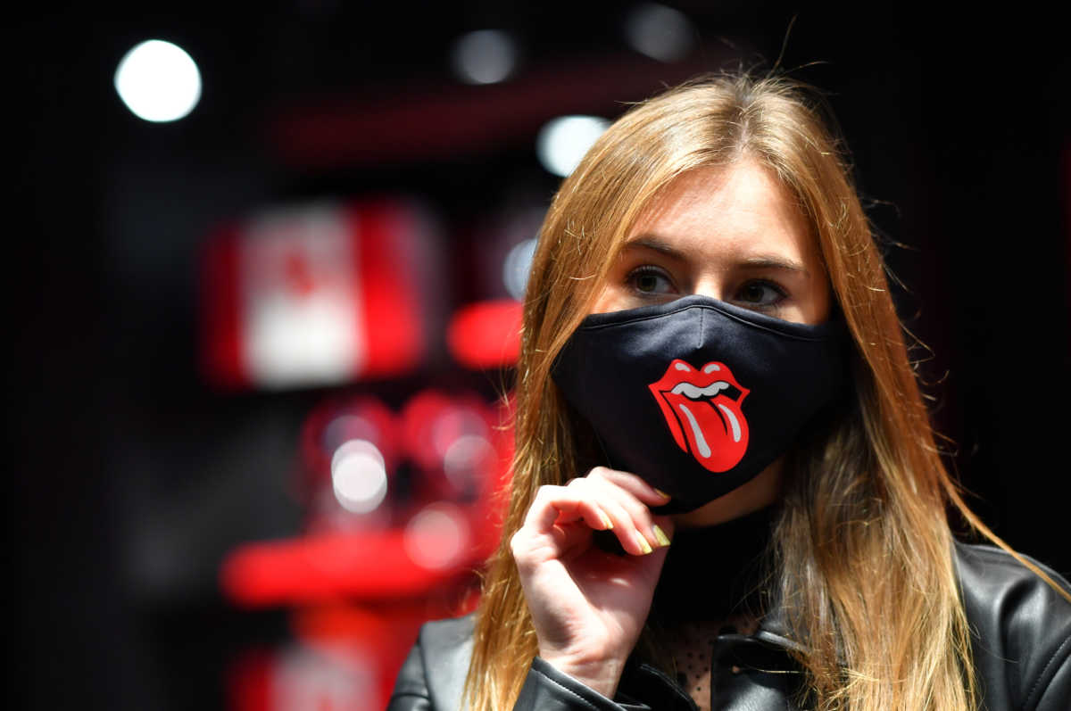 A shop assistant checks a face mask, at the new flagship Rolling Stones store named 'RS No. 9 Carnaby' in London, Britain, September 8, 2020. REUTERS
