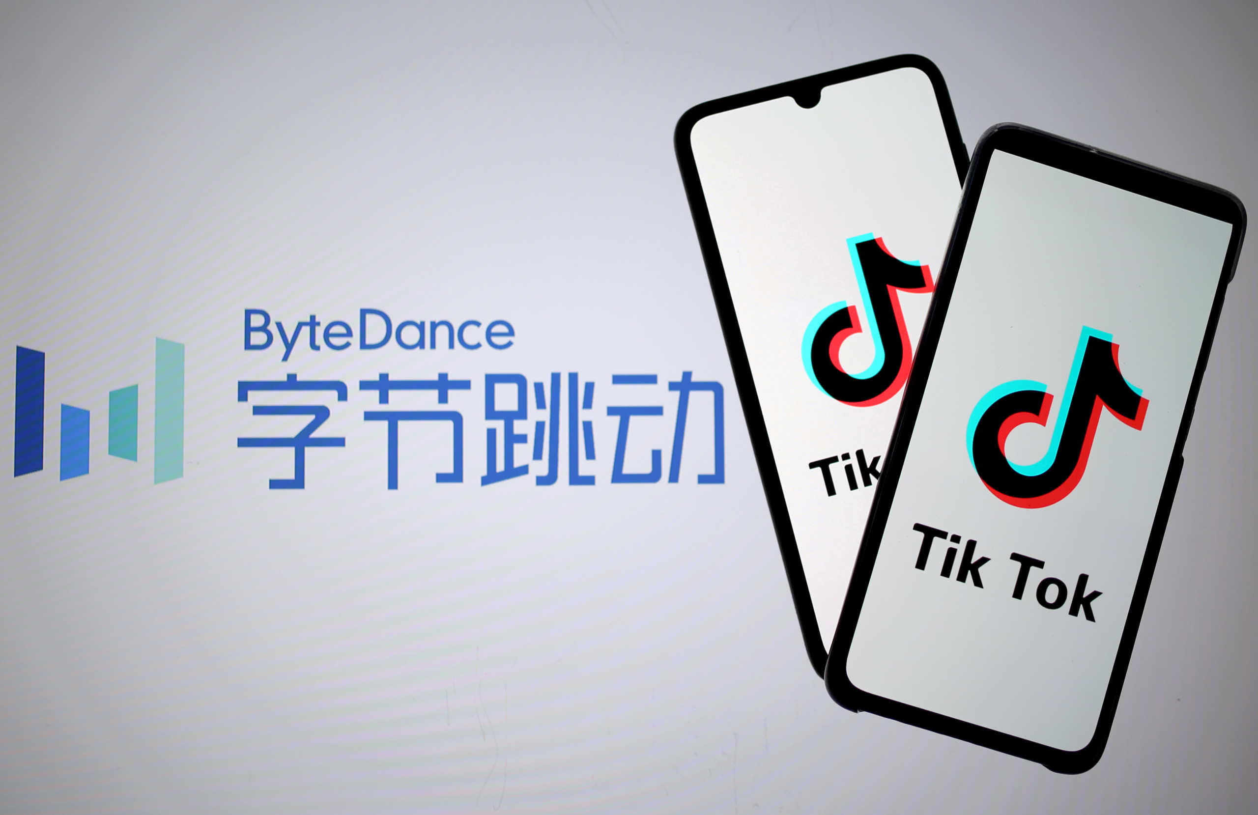 FILE PHOTO: Tik Tok logos are seen on smartphones in front of a displayed ByteDance logo in this illustration taken November 27, 2019. REUTERS
