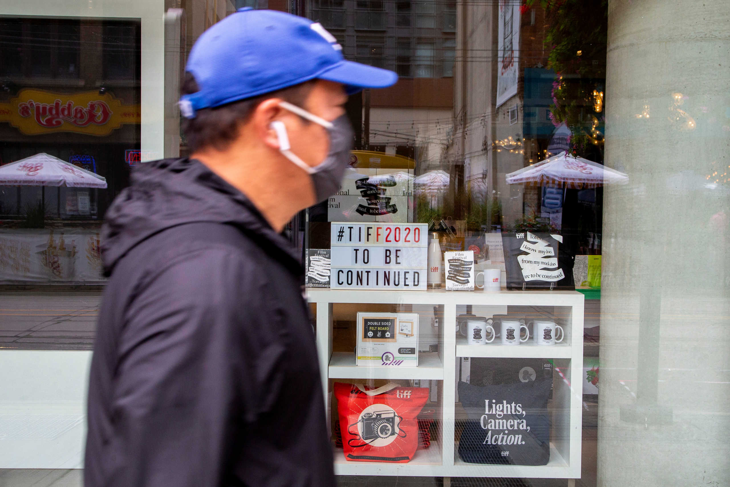 A man wears a face mask is seen at King Street West as the street is nearly empty a day before the Toronto Film Festival, held mainly online due to coronavirus disease (COVID-19) precautions, begins in Toronto, Ontario, Canada September 9, 2020. REUTERS