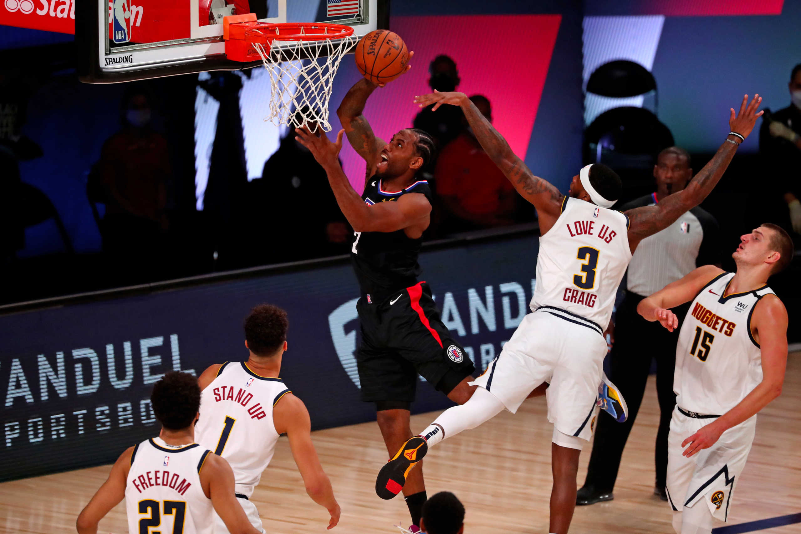 Sep 3, 2020; Lake Buena Vista, Florida, USA; LA Clippers forward Kawhi Leonard (2) drives to the basket around Denver Nuggets forward Torrey Craig (3) during the first half in game one of the second round of the 2020 NBA Playoffs at AdventHealth Arena. Mandatory Credit: Kim Klement-USA TODAY Sports
