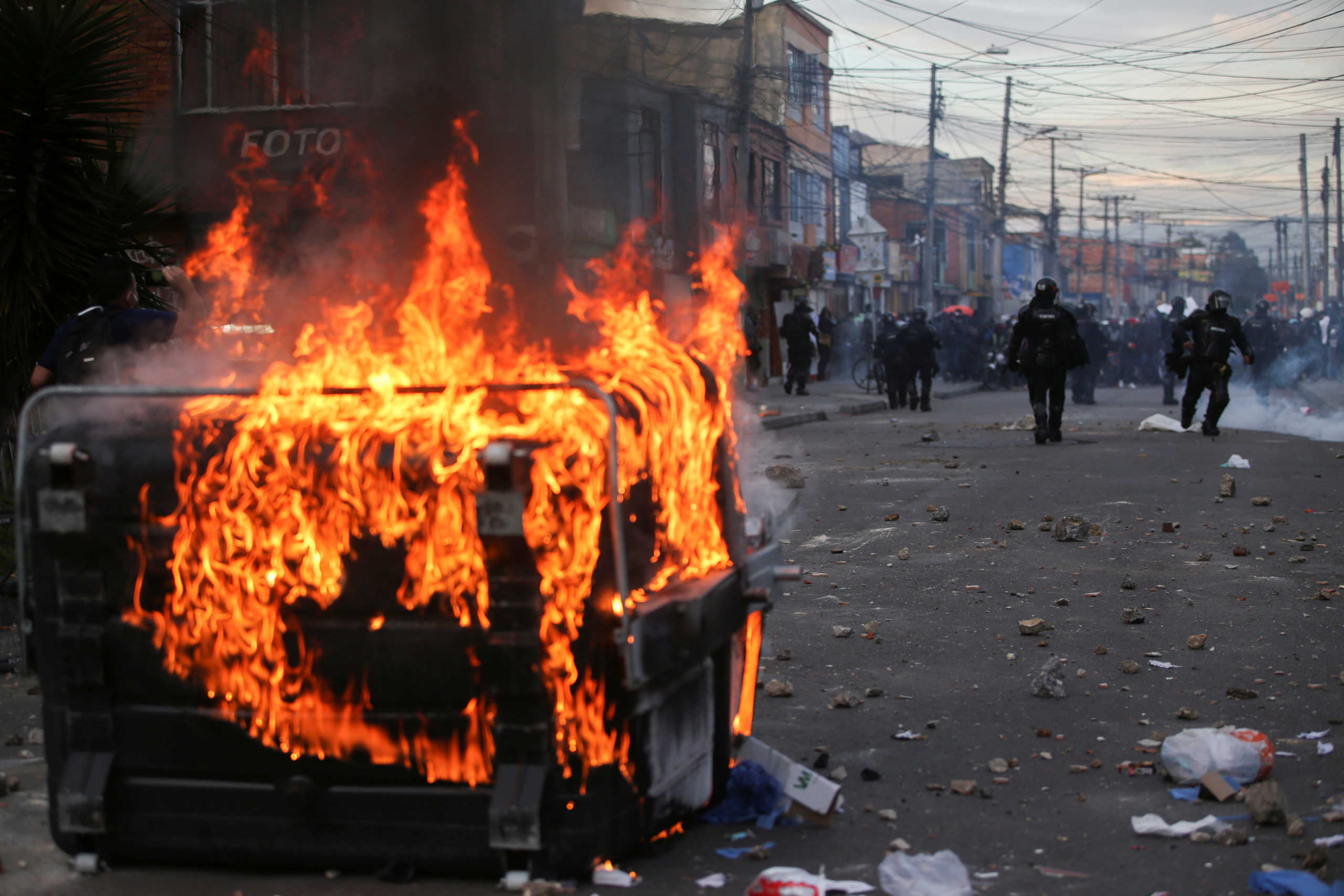 A garbage container burns during protests after a man, who was detained for violating social distancing rules, died from being repeatedly shocked with a stun gun by officers, according to authorities, in Bogota, Colombia September 9, 2020. REUTERS