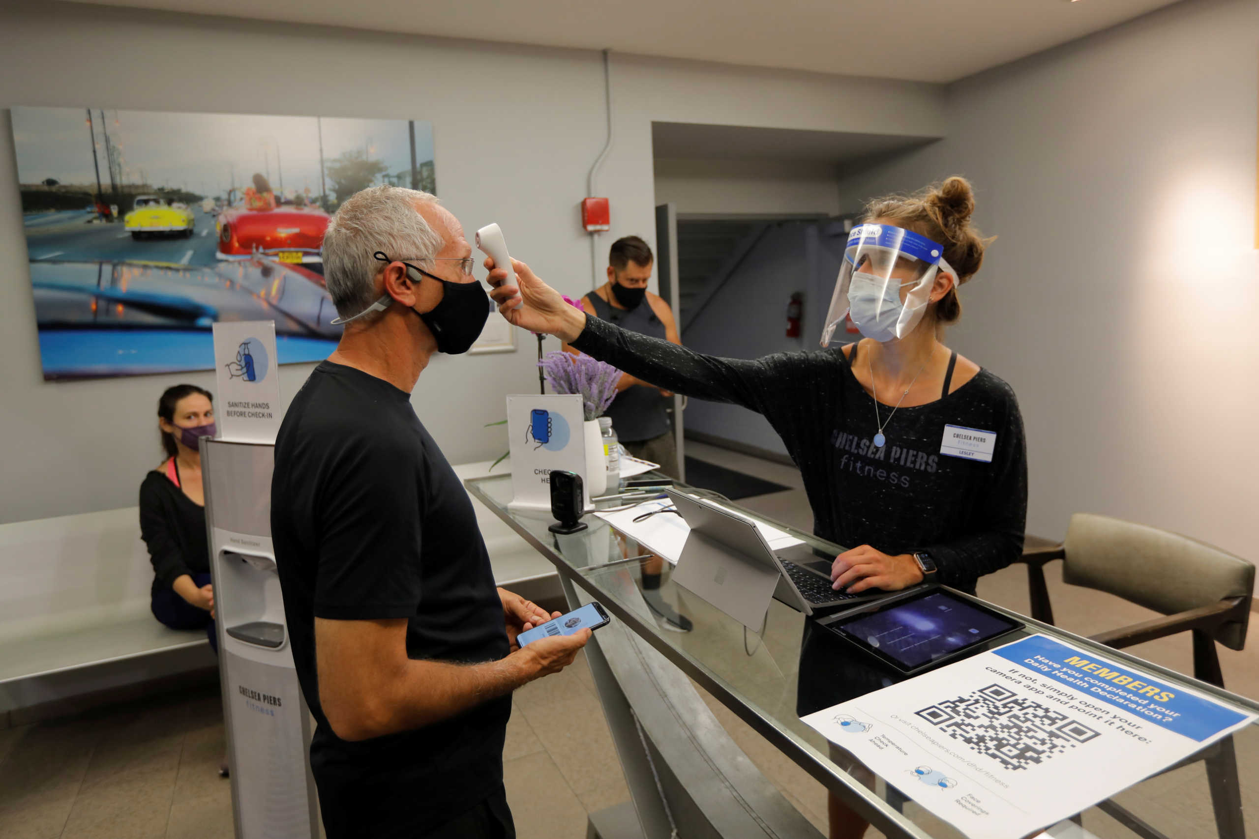 A member gets a temperature check upon arrival at Chelsea Piers Fitness, Manhattan's largest fitness facility on the first day of the re-opening of gyms in New York City following the outbreak of the coronavirus disease (COVID-19) in New York, U.S., September 2, 2020. REUTERS