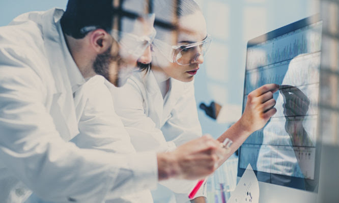 scientists looking at a DNA sequence on the monitor