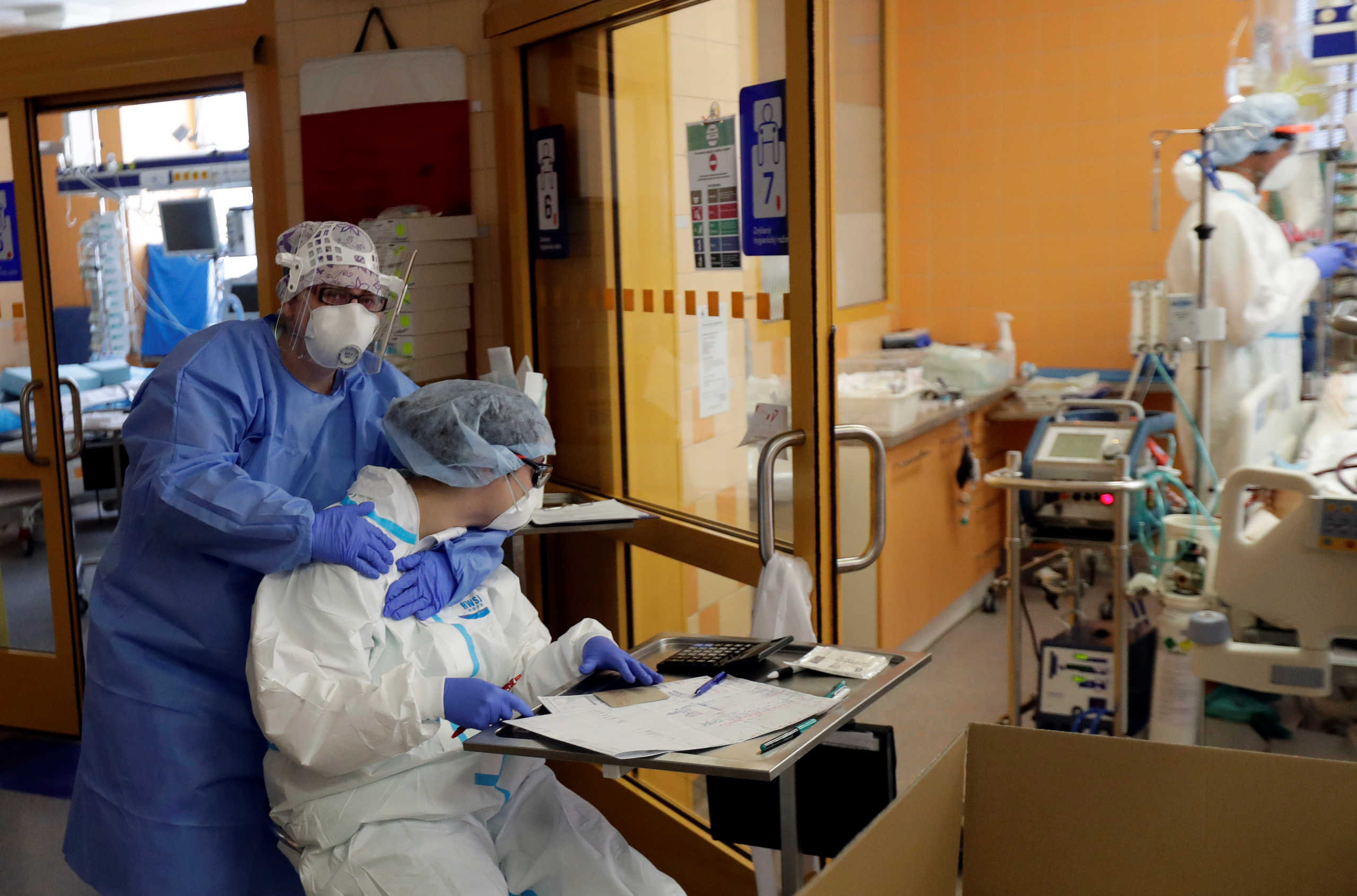 Members of the medical staff embrace as they treat patients suffering from the coronavirus disease (COVID-19) at the Intensive Care Unit (ICU) of the General University Hospital in Prague, Czech Republic, September 22, 2020. REUTERS
