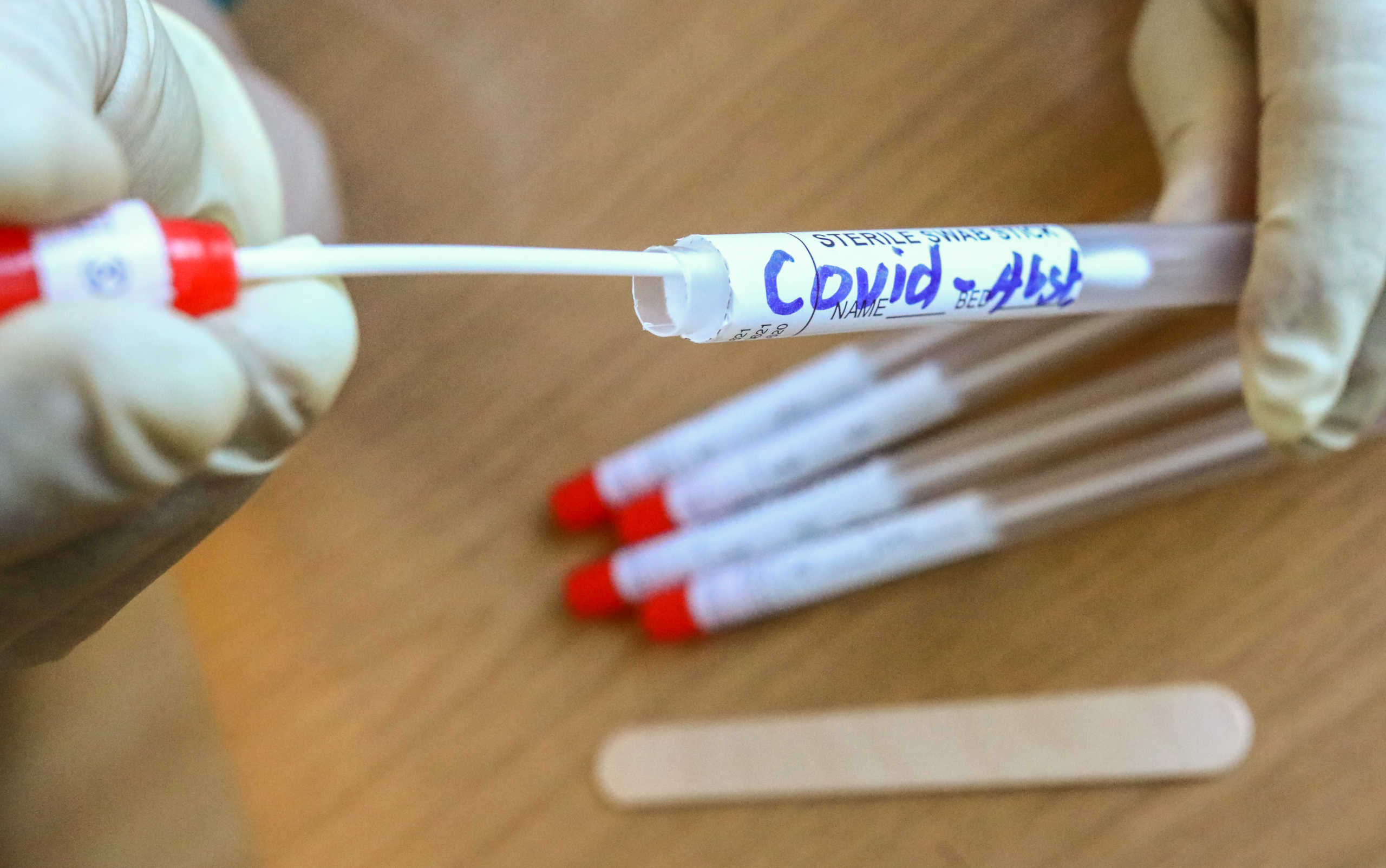 A health worker handles swab samples for the coronavirus disease (COVID-19) tests in Berlin, Germany September 22, 2020. REUTERS