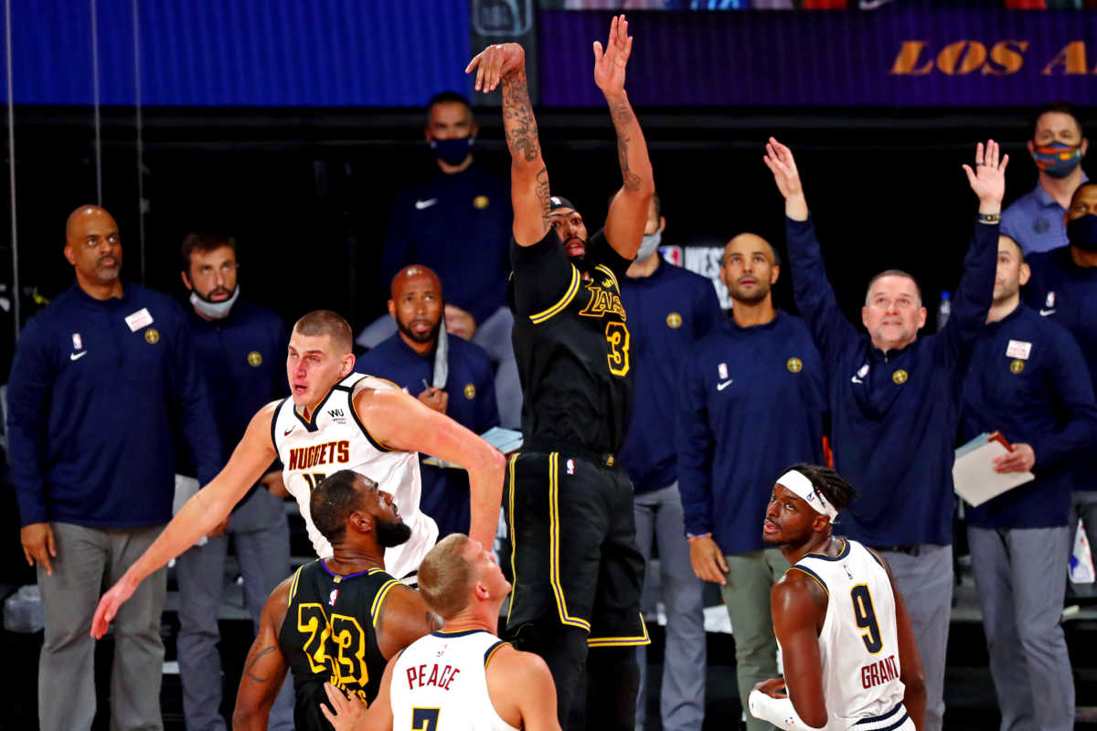 Sep 20, 2020; Lake Buena Vista, Florida, USA; Los Angeles Lakers forward Anthony Davis (3) makes the game winning basket against Denver Nuggets center Nikola Jokic (15) during the fourth quarter in game two of the Western Conference Finals of the 2020 NBA Playoffs at AdventHealth Arena. Mandatory Credit: Kim Klement-USA TODAY Sports