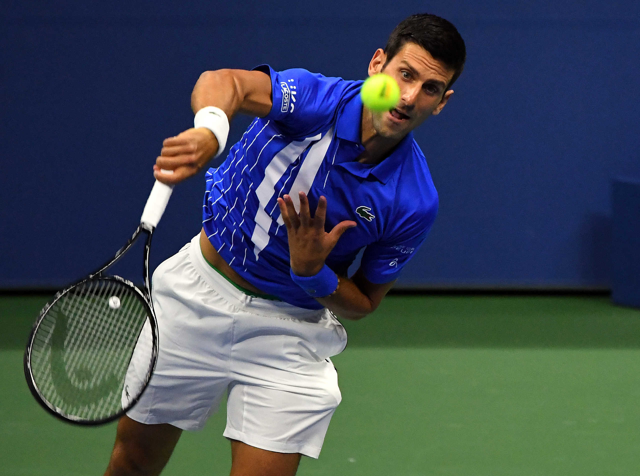 Aug 31, 2020; Flushing Meadows, New York, USA; Novak Djokovic (SRB) hits the ball against Damir Dzumhur (BIH) on day one of the 2020 U.S. Open tennis tournament at USTA Billie Jean King National Tennis Center. Mandatory Credit: Robert Deutsch-USA TODAY Sports