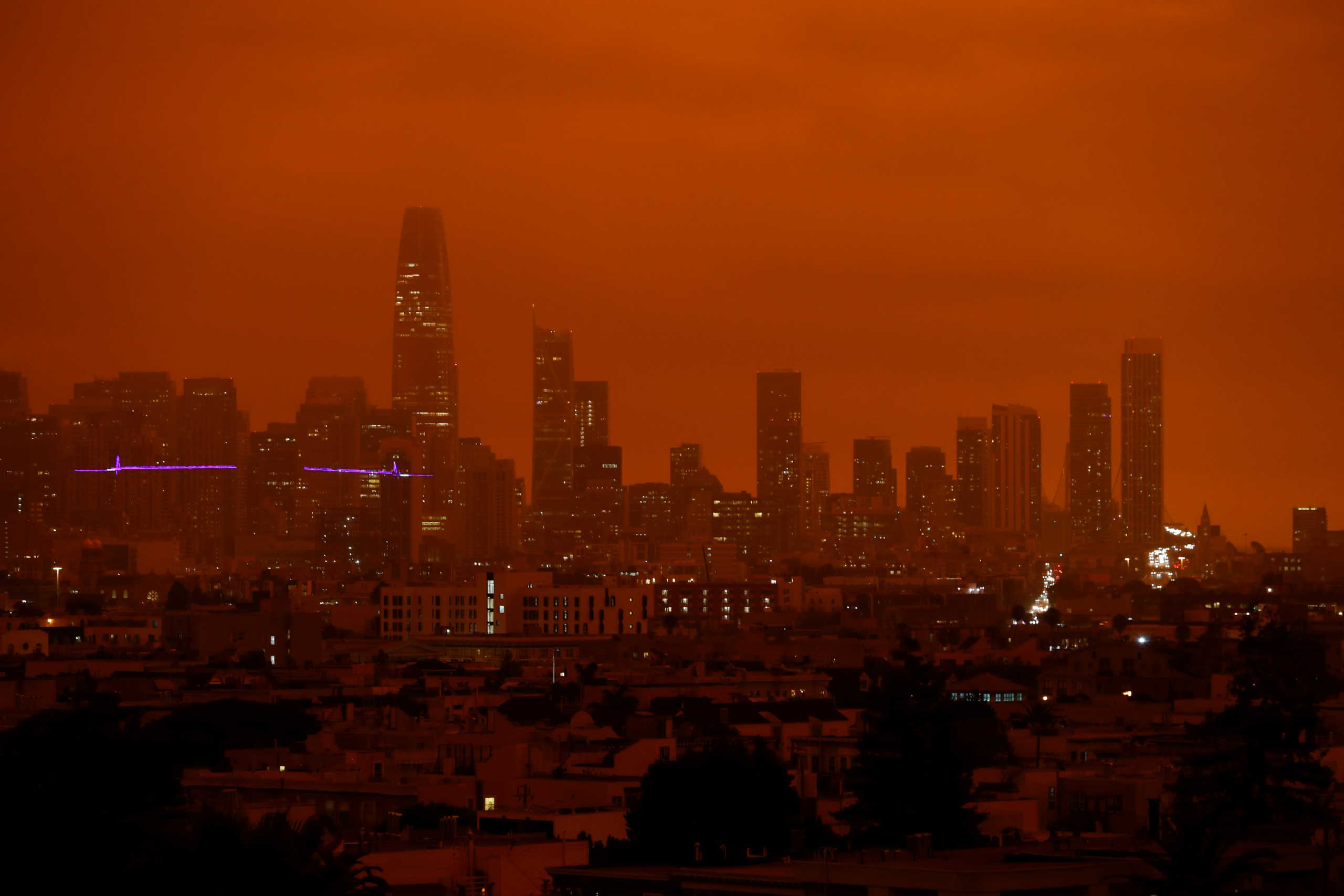 Downtown San Francisco is seen from Dolores Park under an orange sky darkened by smoke from California wildfires in San Francisco, California, U.S. September 9, 2020. REUTERS