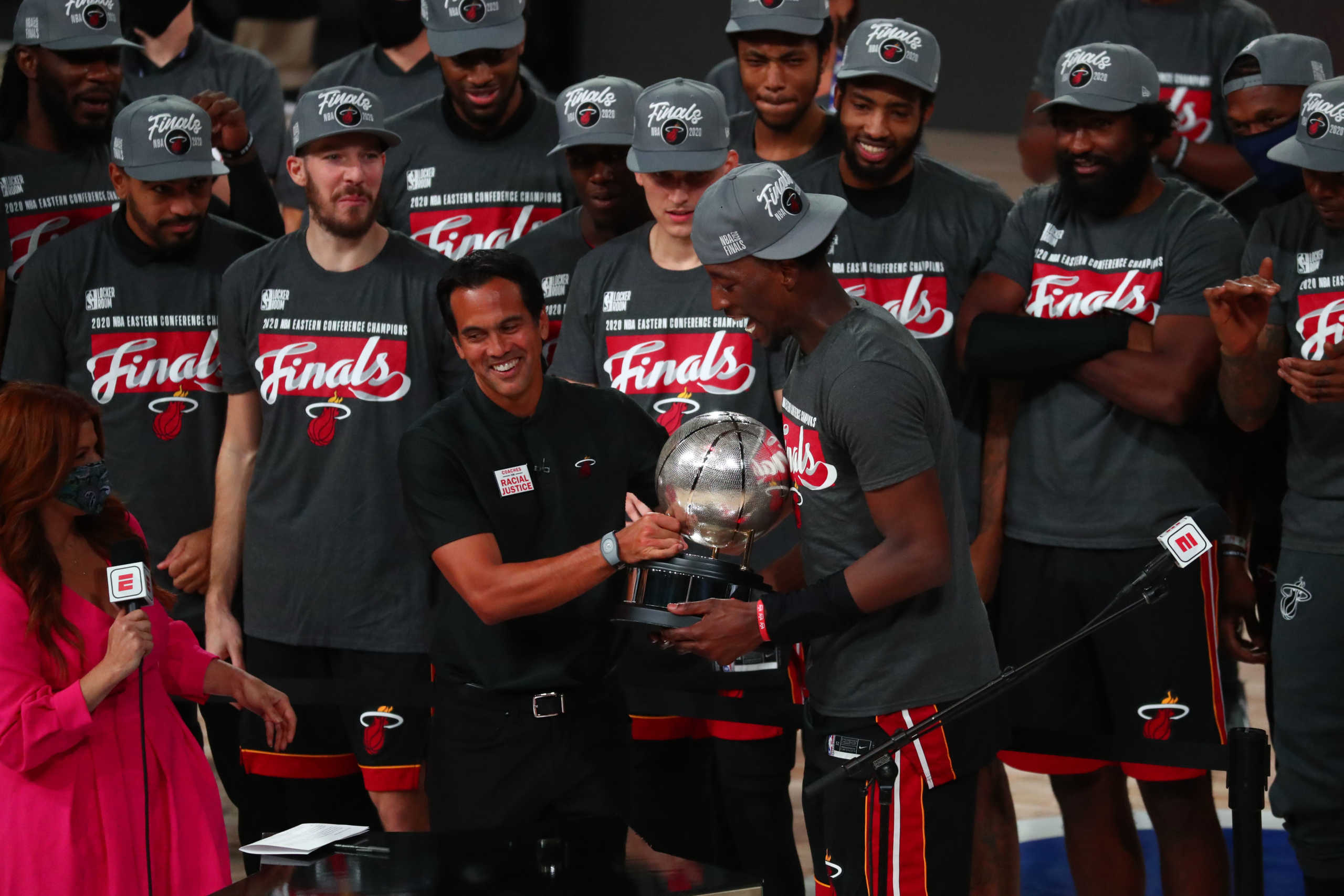 Sep 27, 2020; Lake Buena Vista, Florida, USA; Miami Heat head coach Erik Spoelstra hands the Eastern Conference Championship trophy to forward Bam Adebayo (13) after defeating the Boston Celtics in game six of the Eastern Conference Finals of the 2020 NBA Playoffs at AdventHealth Arena. Mandatory Credit: Kim Klement-USA TODAY Sports