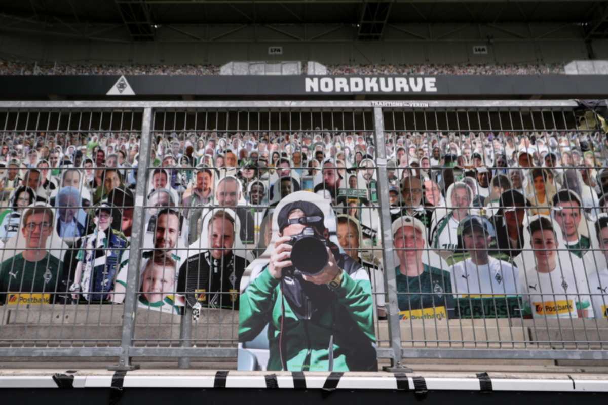 epa08512185 A cardboard cut-out of a photographer is seen  during the German Bundesliga soccer match between Borussia Moenchengladbach and Hertha BSC at Borussia-Park in Moenchengladbach, Germany, 27 June 2020.  EPA