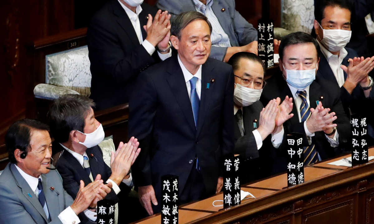 Japan's newly-elected Prime Minister Yoshihide Suga stands as he was chosen as new prime minister at the Lower House of Parliament in Tokyo, Japan September 16, 2020. REUTERS