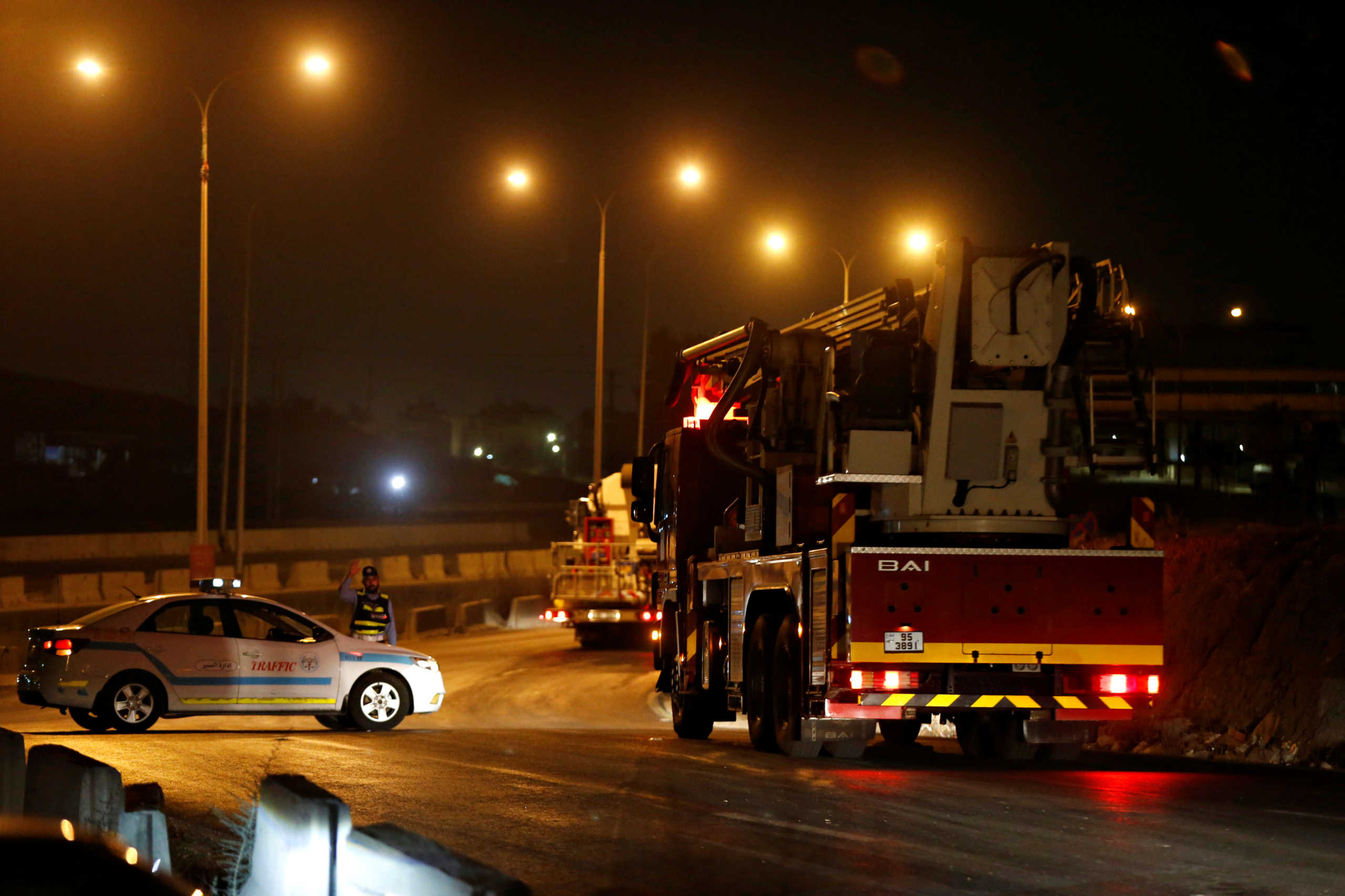Civil defense vehicles leave for Amman at the highway between Jordanian capital of Amman and the city of Zarqa, after of large explosions at a Jordanian army base outside Zarqa on the northeastern edge of Amman, Jordan, September 11, 2020. REUTERS