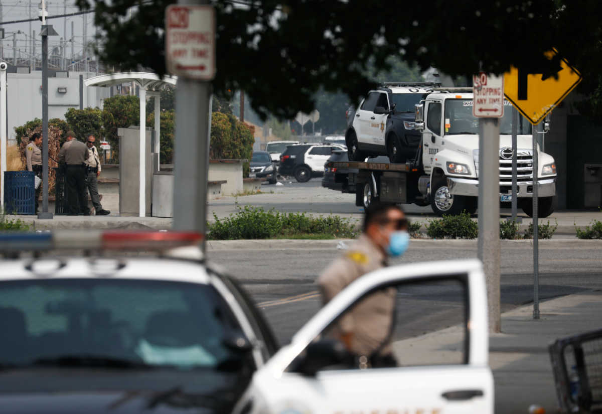 A Los Angeles County Sheriffs Department vehicle is towed from the scene where two deputies were shot in an ambush style shooting in Compton, California, U.S., September 13, 2020. REUTERS