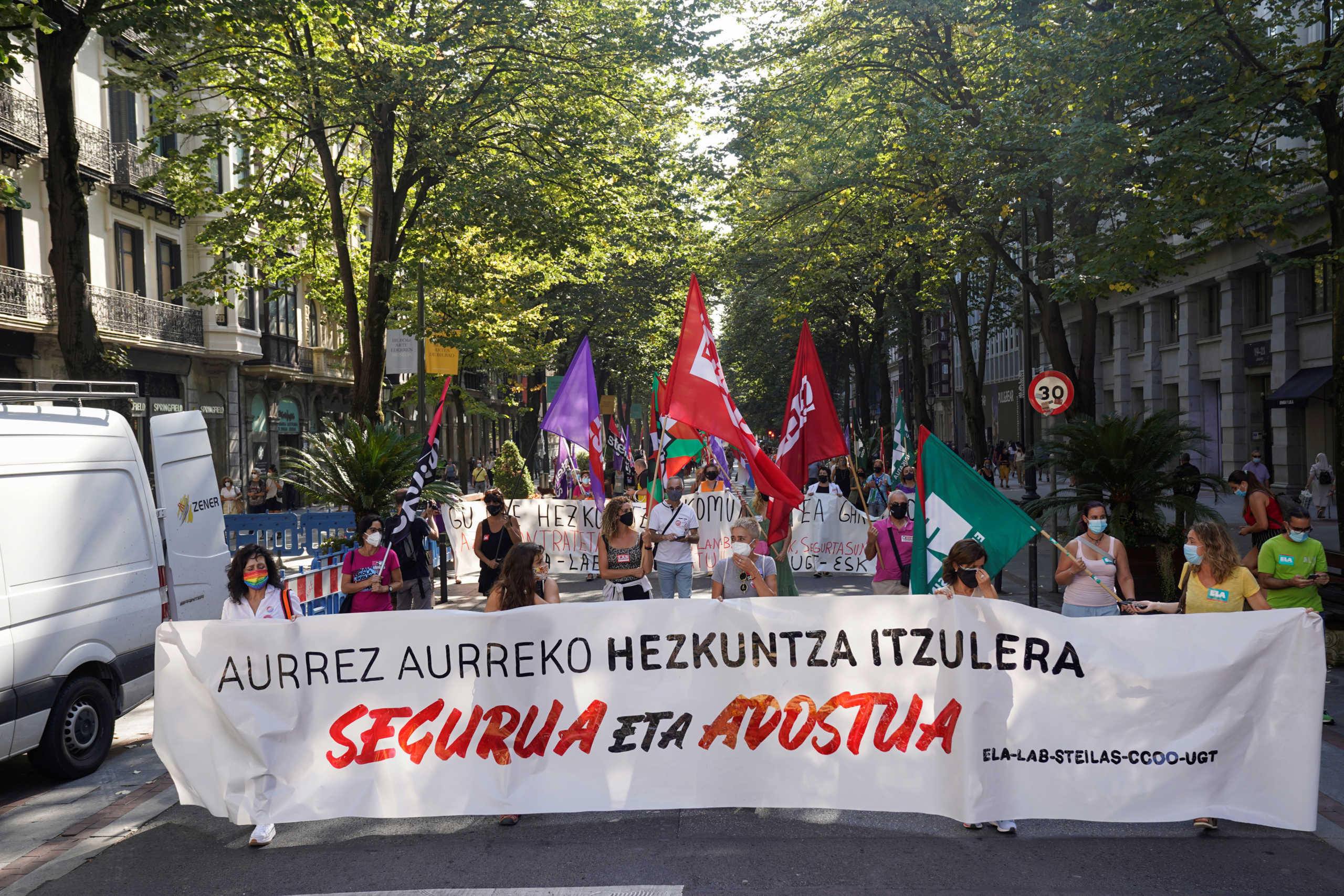 People carry a banner reading "A safe and negotiated return to education", during a one day strike called by trade unions to protest the Basque regional government's response to the coronavirus disease (COVID-19) crisis in education, Bilbao, Spain, September 15, 2020. REUTERS
