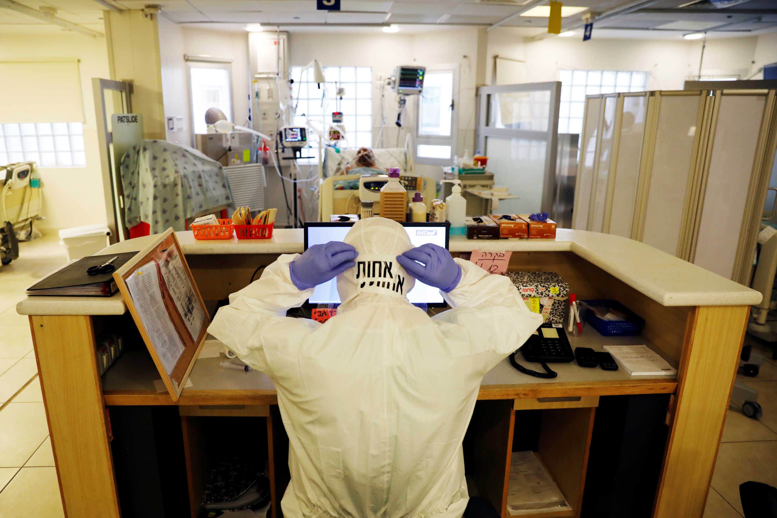 A hospital staffer fixes her protective suite at a coronavirus disease (COVID-19) ward amid a surge in new cases that has forced Israel into a second nationwide lockdown, at Tel Aviv Sourasky Medical Center (Ichilov), Tel Aviv, Israel September 21, 2020. Picture taken September 21, 2020.  REUTERS