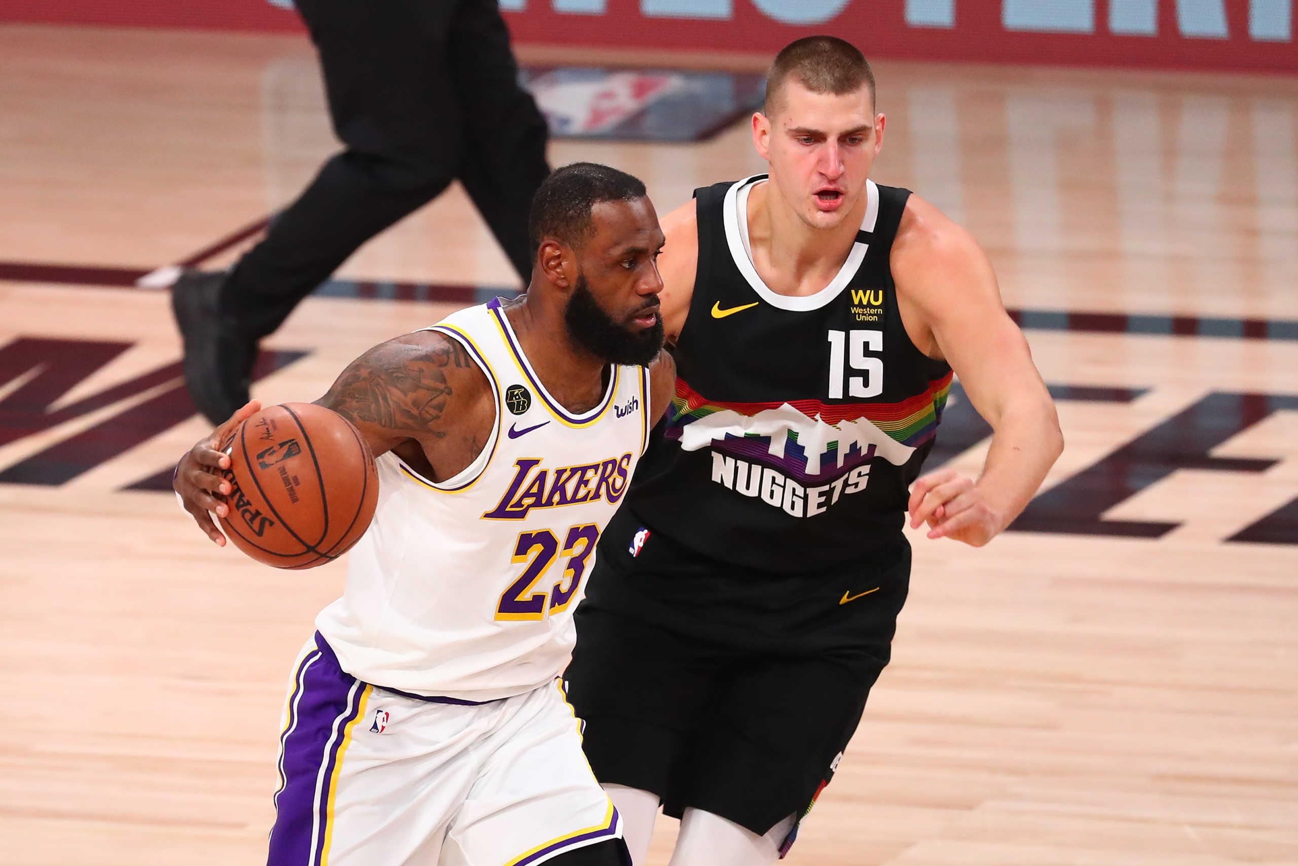 Sep 22, 2020; Lake Buena Vista, Florida, USA; Los Angeles Lakers forward LeBron James (23) dribbles the ball against Denver Nuggets center Nikola Jokic (15) during the first half of game three of the Western Conference Finals of the 2020 NBA Playoffs at AdventHealth Arena. Mandatory Credit: Kim Klement-USA TODAY Sports