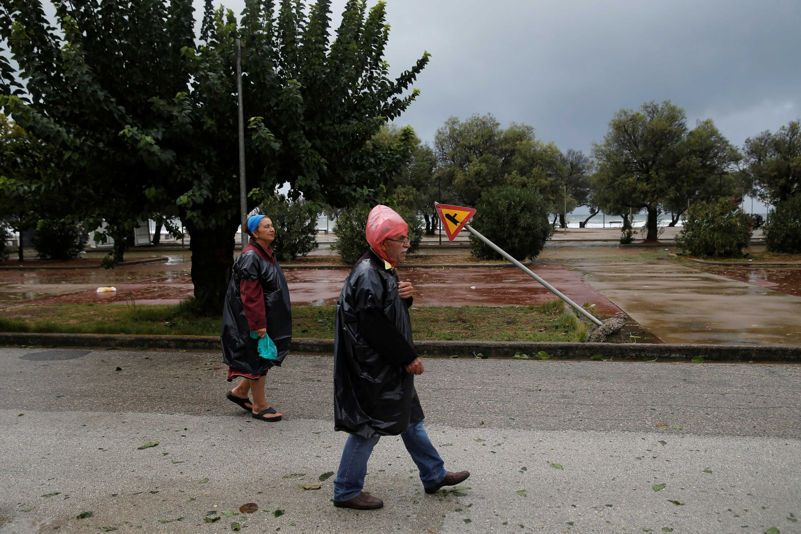 People walk near the town of Amaliada, as a rare storm, known as a Medicane (Mediterranean hurricane), hit western Greece, September 18, 2020. REUTERS