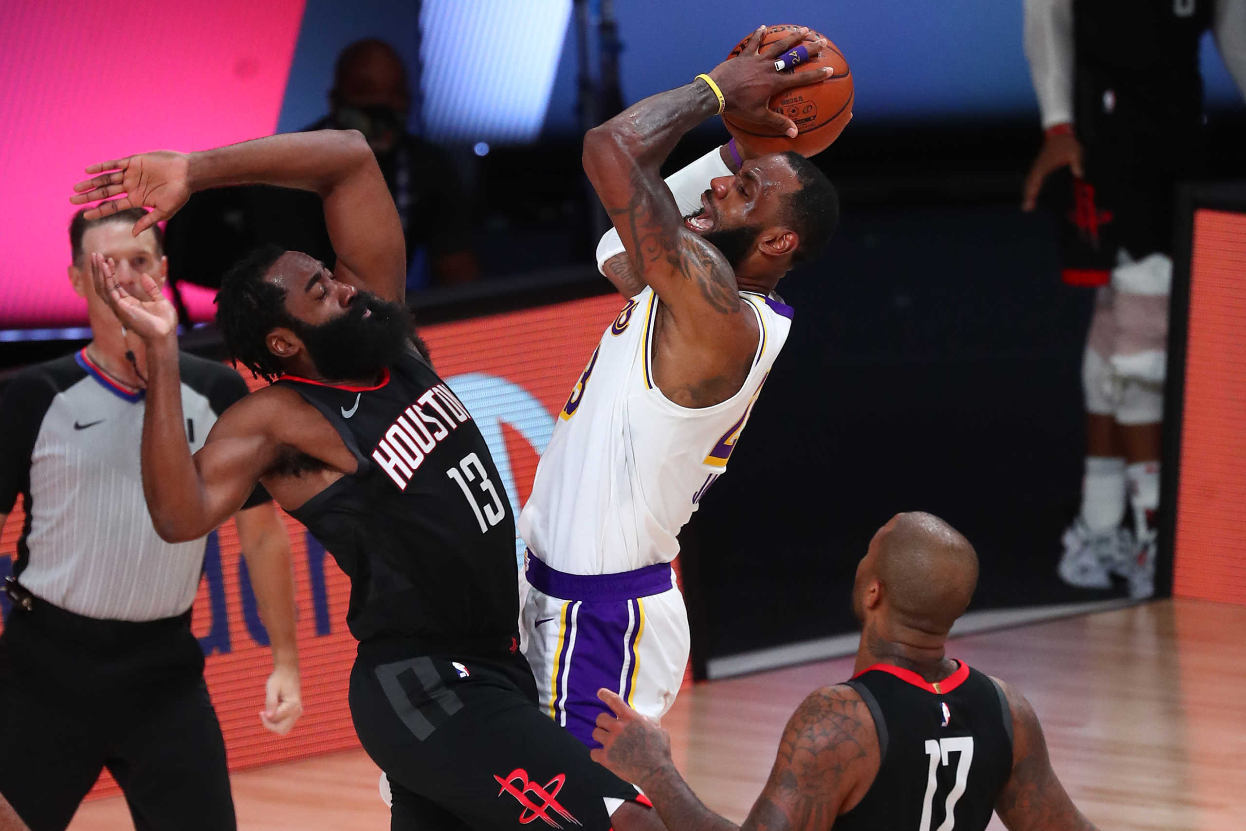 Sep 8, 2020; Lake Buena Vista, Florida, USA; Los Angeles Lakers forward LeBron James (middle) shoots against Houston Rockets guard James Harden (13) and forward P.J. Tucker (17) during the second half of game three in the second round of the 2020 NBA Playoffs at AdventHealth Arena. Mandatory Credit: Kim Klement-USA TODAY Sports