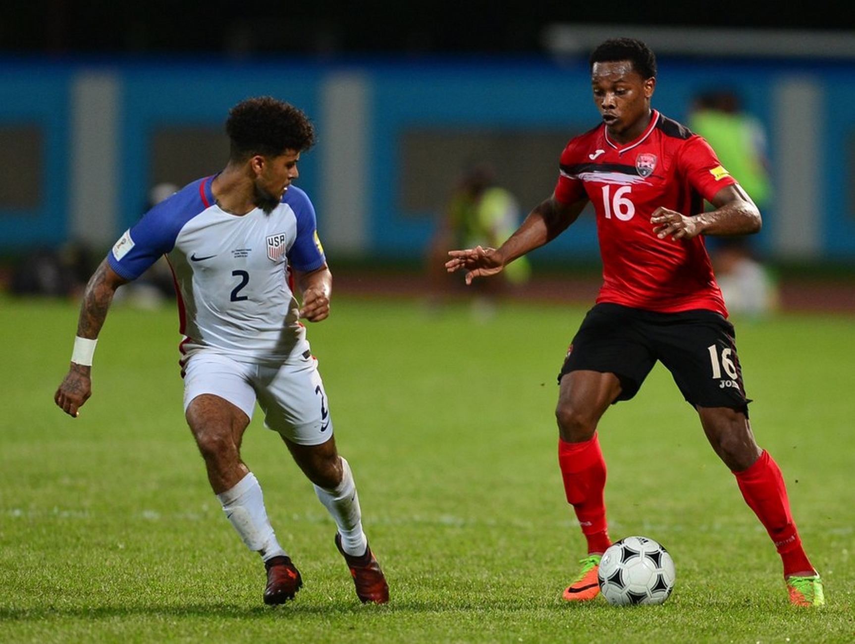 epa06258114 Deandre Yedlin of the USA (L) vies for the ball with Trinidad and Tobago's Levi Garcia (R) during their 2018 FIFA World Cup Russia qualifier at Ato Boldon Stadium in Couva, Trinidad and Tobago, 10 October 2017.  EPA