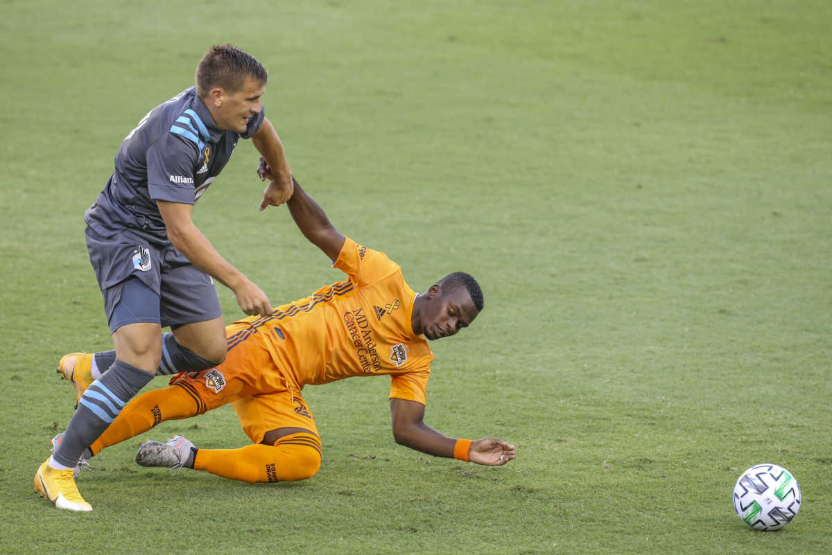 Sep 2, 2020; Houston, Texas, USA; Minnesota United midfielder Robin Lod (17) pulls down Houston Dynamo forward Carlos Darwin Quintero (23) in the first half at BBVA Compass Stadium. Mandatory Credit: Thomas Shea-USA TODAY Sports