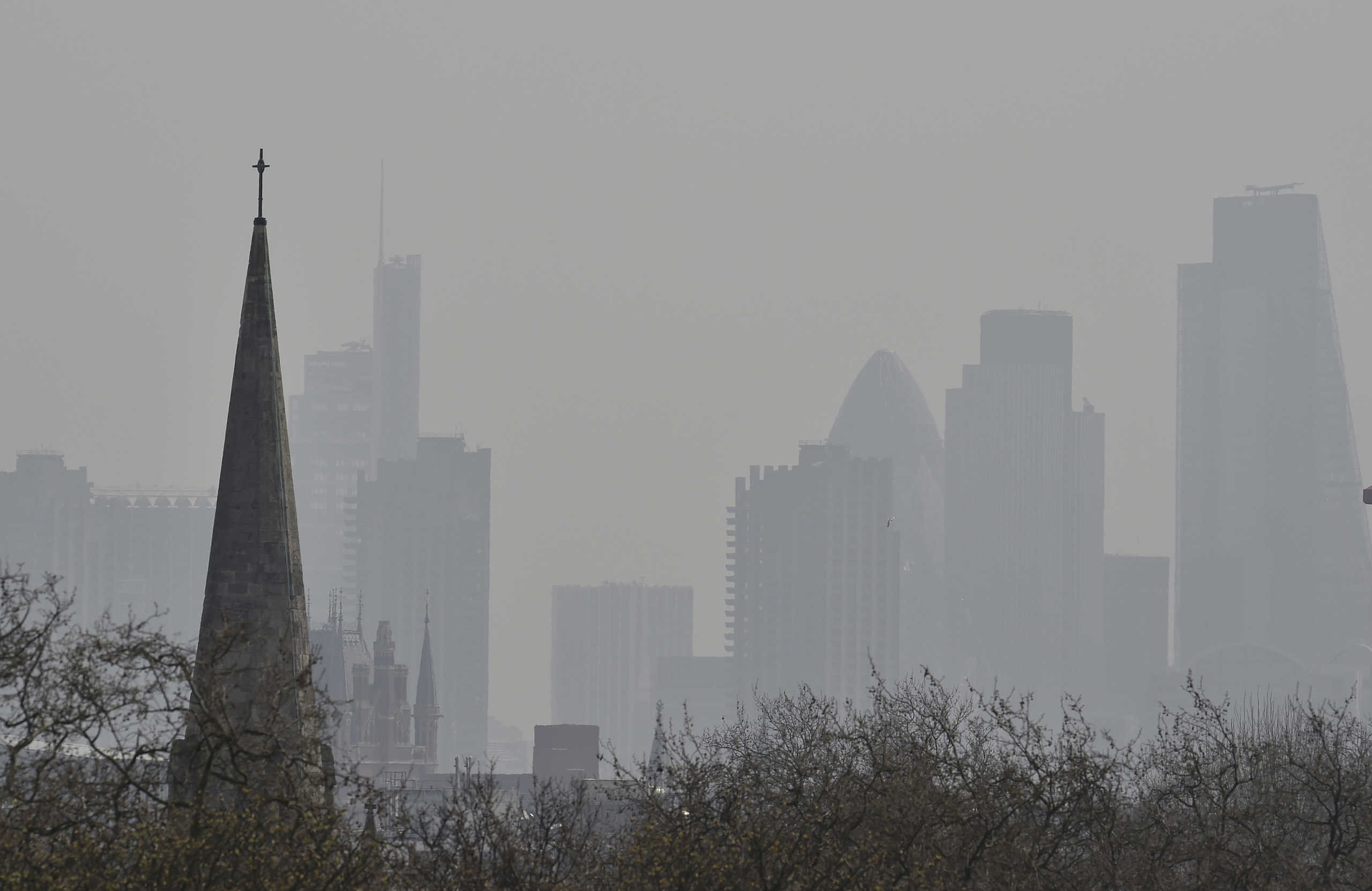 FILE PHOTO: The City of London financial district is seen from Primrose Hill as high air pollution obscures the skyline over London April 10, 2015. . REUTERS