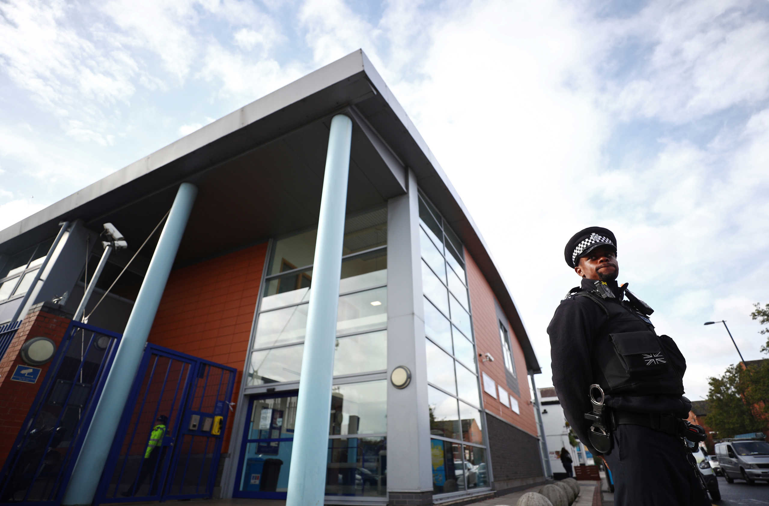 A policeman stands guard outside the custody centre where a British police officer has been shot dead in Croydon, south London, Britain, September 25, 2020. REUTERS