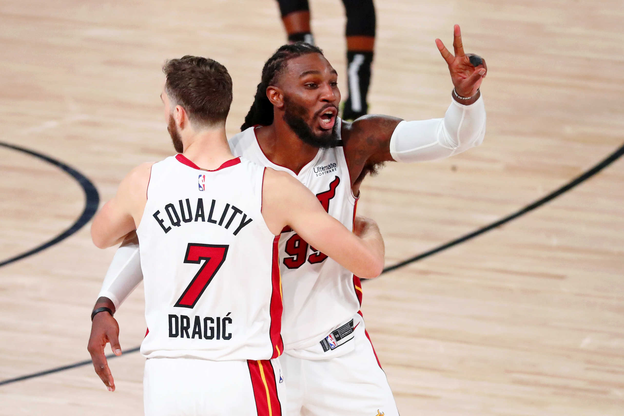 Sep 17, 2020; Lake Buena Vista, Florida, USA; Miami Heat forward Jae Crowder (99) holds up two fingers after winning game two of the Eastern Conference Finals of the 2020 NBA Playoffs against the Boston Celtics as he celebrates with guard Goran Dragic (7) at ESPN Wide World of Sports Complex. The Miami Heat wn 106-101. Mandatory Credit: Kim Klement-USA TODAY Sports