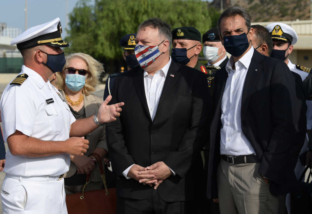 U.S. Secretary of State Mike Pompeo stands alongside Greek Prime Minister Kyriakos Mitsotakis (R) during their visit to the Naval Support Activity base at Souda, Greece September 29, 2020.  Aris Messinis