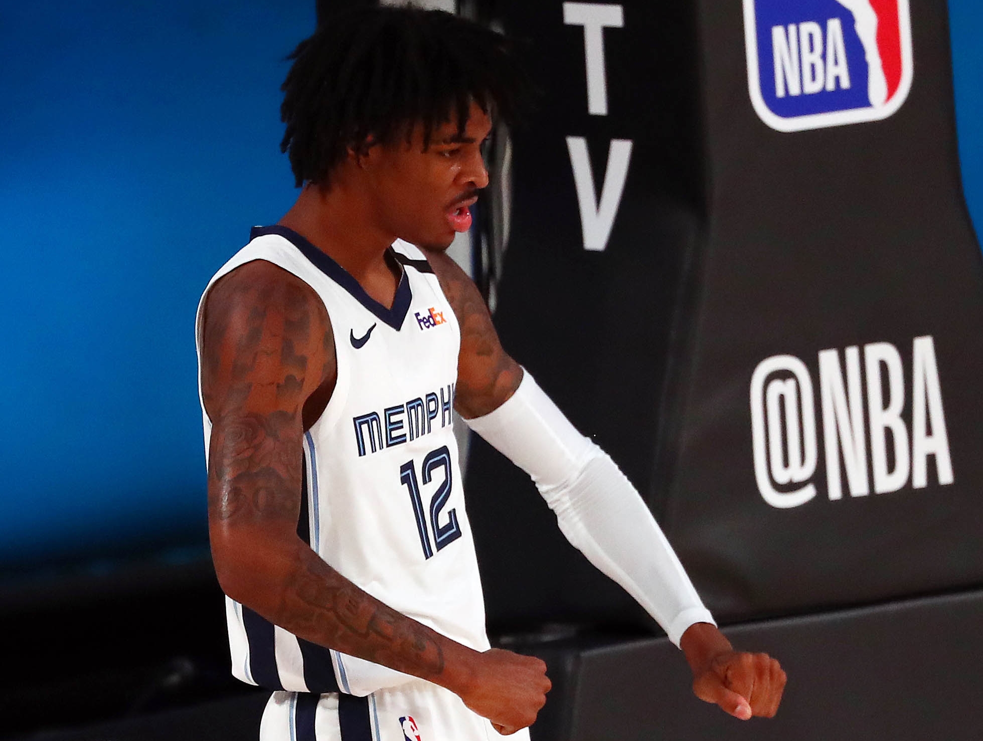 August 7, 2020; Lake Buena Vista, Florida, USA; Memphis Grizzlies guard Ja Morant (12) reacts after scoring a basket and drawing a foul against the Oklahoma City Thunder during the first half of an NBA game at Visa Athletic Center. Mandatory Credit: Kim Klement-USA TODAY Sports