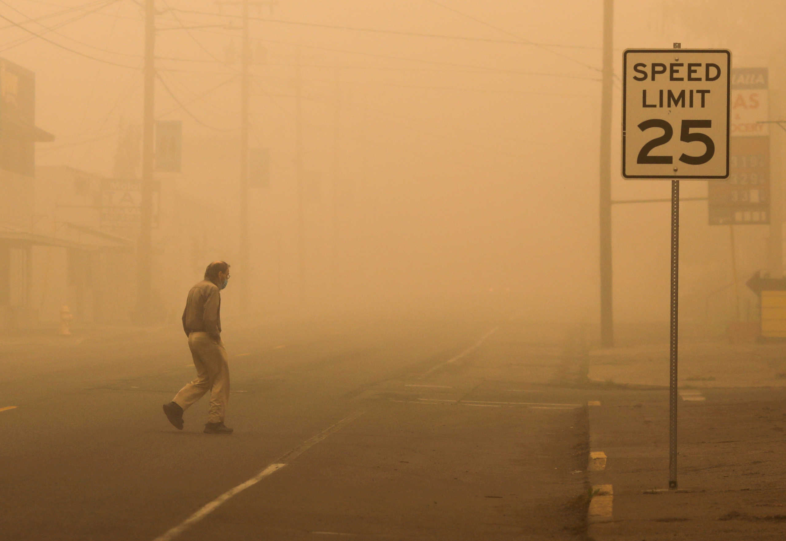 A man walks through a street in the town where about 10,000 residents were evacuated as the fire continues, in Molalla, Oregon, U.S., September 11, 2020. REUTERS
