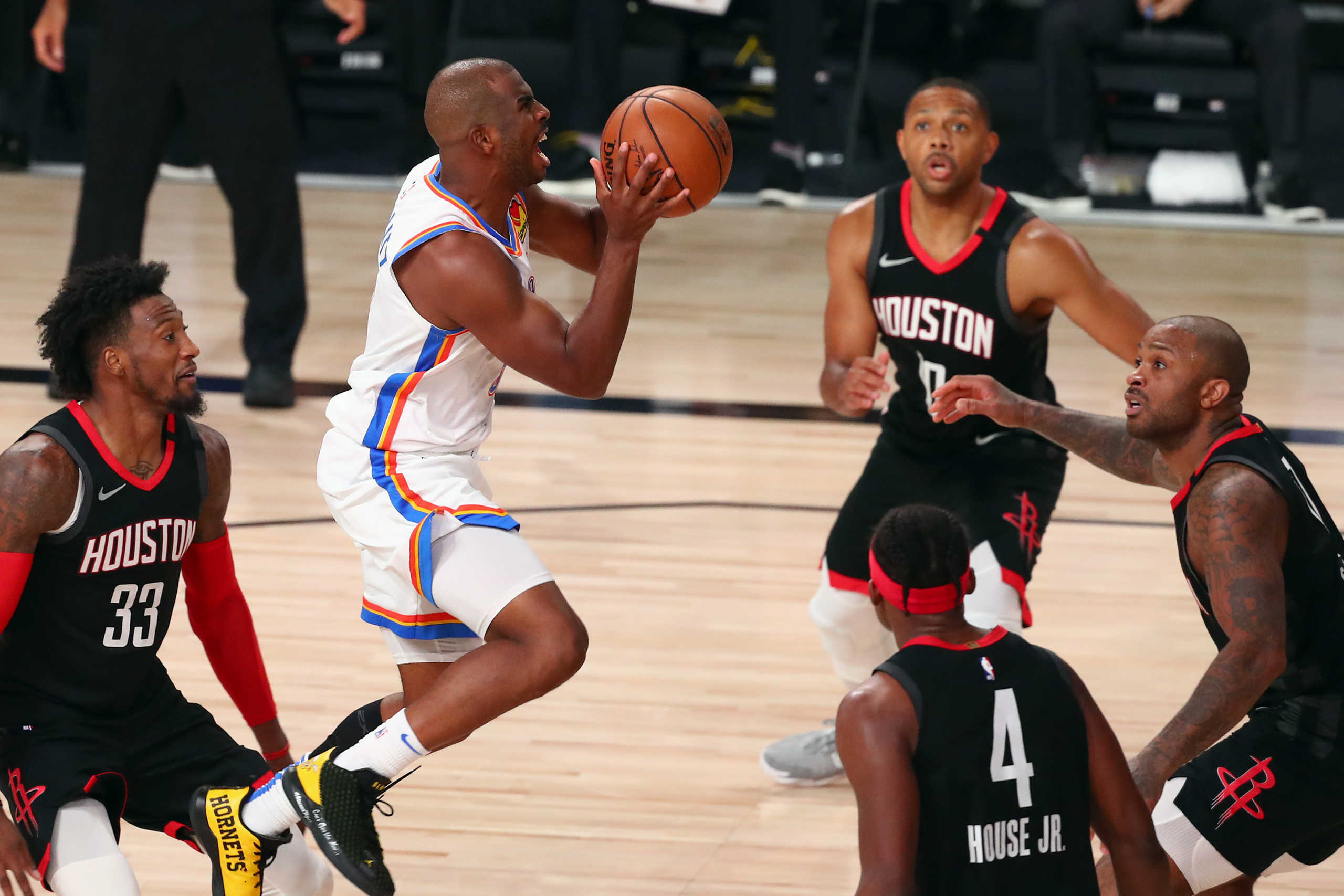 Aug 24, 2020; Lake Buena Vista, Florida, USA; Oklahoma City Thunder guard Chris Paul (middle) shoots against Houston Rockets forward Robert Covington (33) and guard Eric Gordon (10) and forward Danuel House Jr. (4) and forward P.J. Tucker (right) during the second half in game four of the first round of the 2020 NBA Playoffs at AdventHealth Arena. Mandatory Credit: Kim Klement-USA TODAY Sports