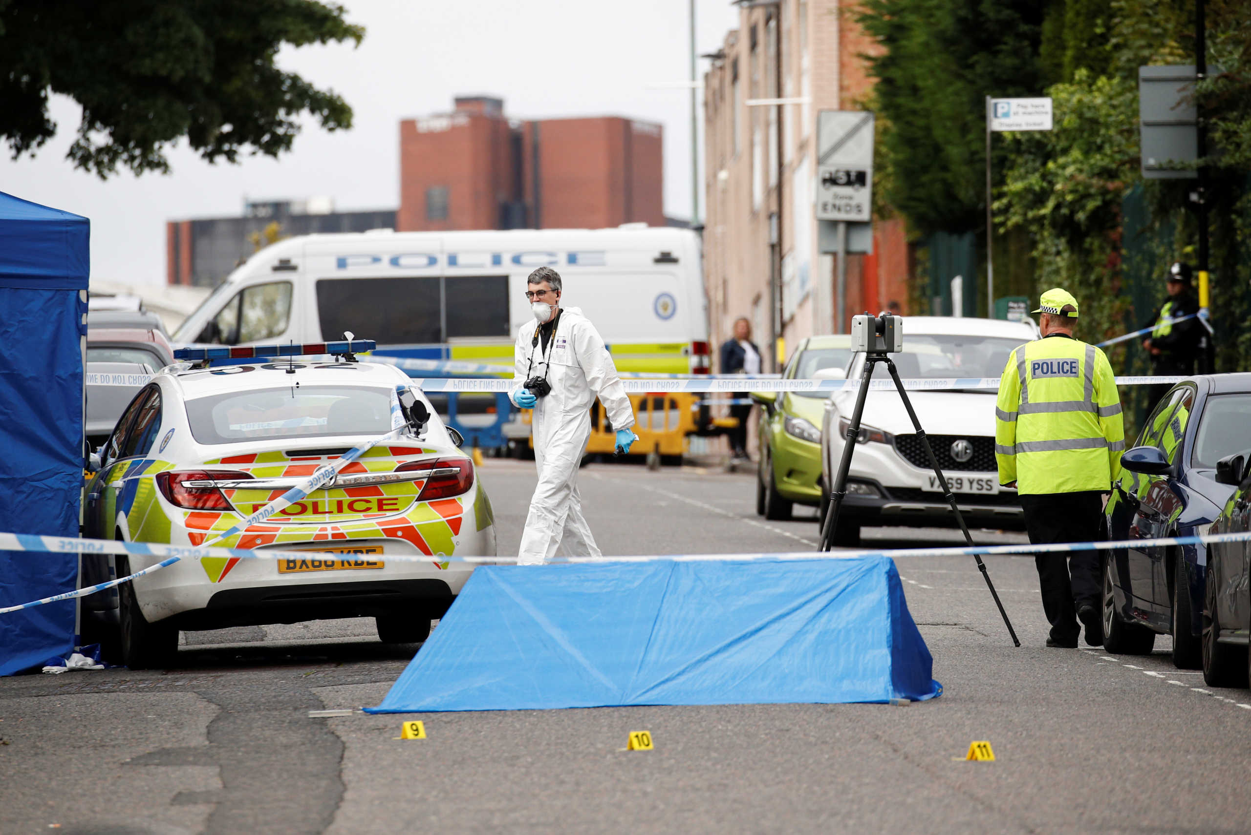 Police officers and a forensic worker are seen at the scene of reported stabbings in Birmingham, Britain, September 6, 2020.  REUTERS