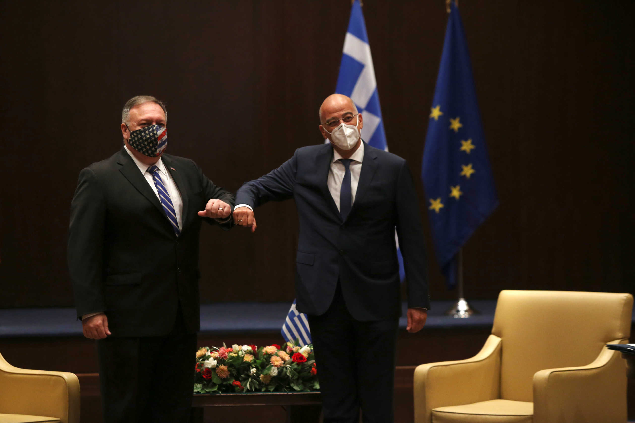 U.S. Secretary of State Mike Pompeo, left, and Greek Foreign Minister Nikos Dendias touch elbows during their meeting in the northern city of Thessaloniki, Greece, Monday, Sept. 28, 2020. Pompeo and Dendias, will sign a bilateral science and technology agreement, as well as host energy sector business leaders for a discussion to highlight energy diversification and infrastructure projects in Greece. (AP Photo