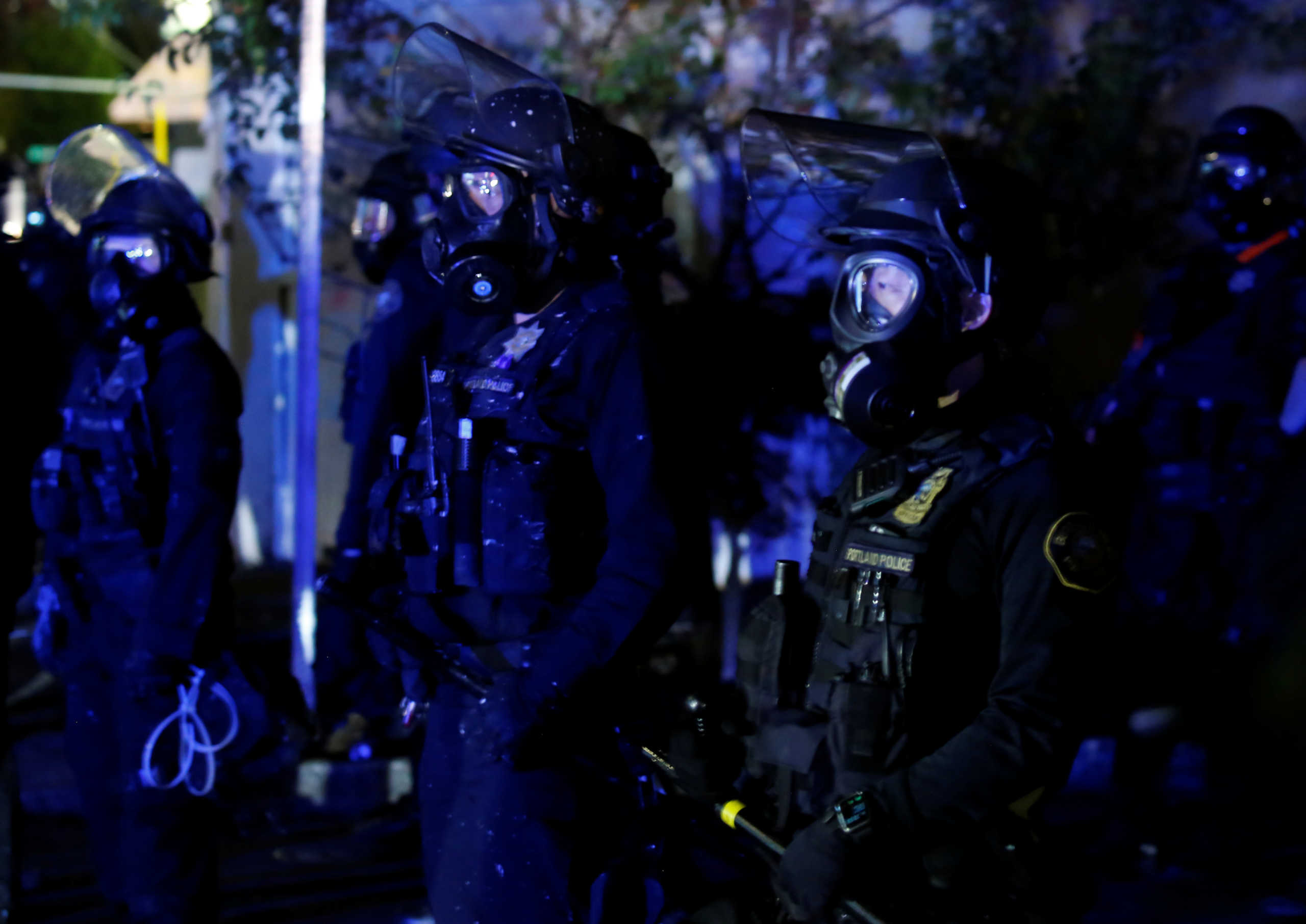 Law enforcement officers and protesters square off during unrest that followed the grand jury decision in Louisville's Breonna Taylor case, in Portland, Oregon, U.S., September 24, 2020. REUTERS