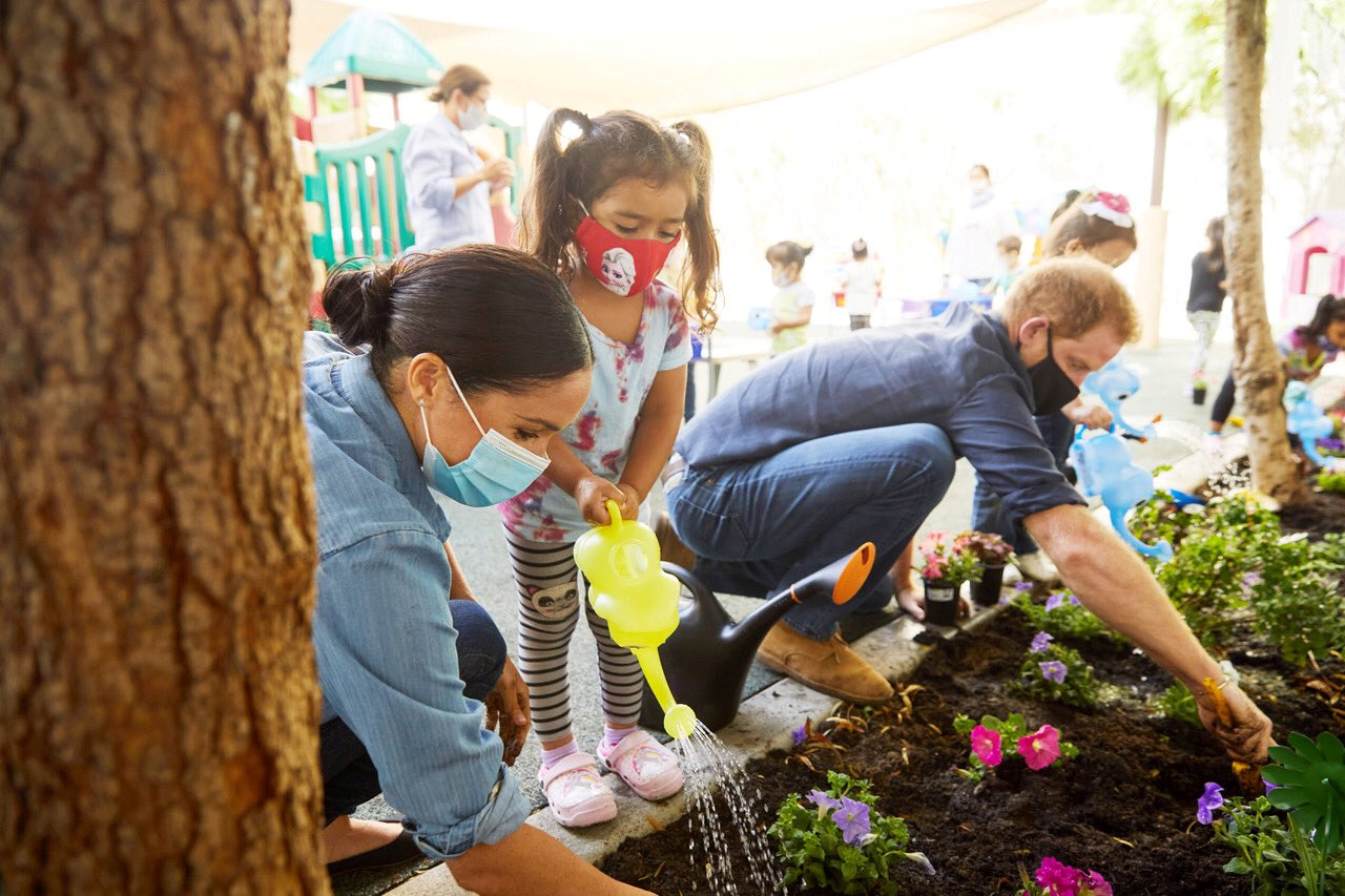 Prince Harry and Meghan Markle, the Duke and Duchess of Sussex, plant flowers and forget-me-nots during a visit to the Assistance League Los Angeles' Preschool Learning Center in Los Angeles, California, U.S. August 31, 2020, in this picture obtained from social media. Picture taken August 31, 2020. Mandatory credit MATT SAYLES