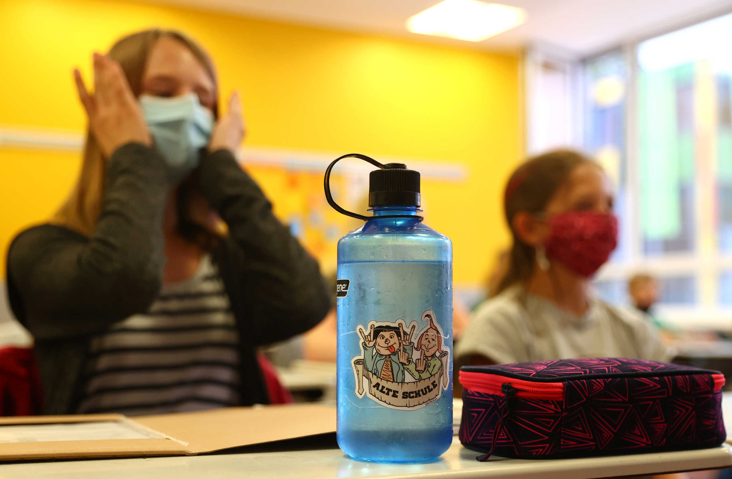 Schoolgirls of the fifth year voluntarily wear protective face masks inside their classroom as schools re-open after summer holidays and the lockdown due to the outbreak of the coronavirus disease (COVID-19) at the Karl-Rehbein high school in Hanau, Germany, August 17, 2020.   REUTERS