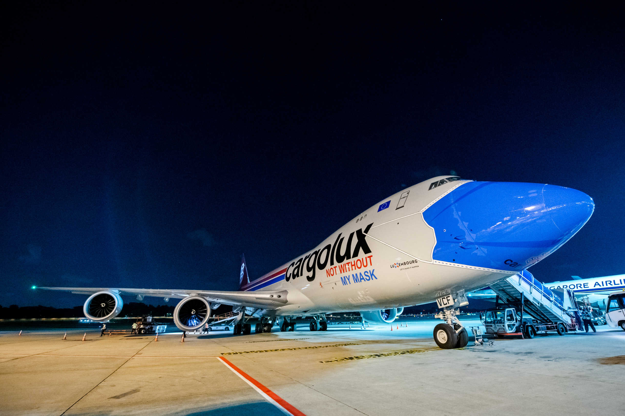 A plane of Luxembourg's Cargolux cargo airline reading ''Not without my mask'' on its body is seen at the Changi Airport, amid the outbreak of the coronavirus disease (COVID-19), in Singapore, August 27, 2020. Picture taken August 27, 2020. Changi Airport Group