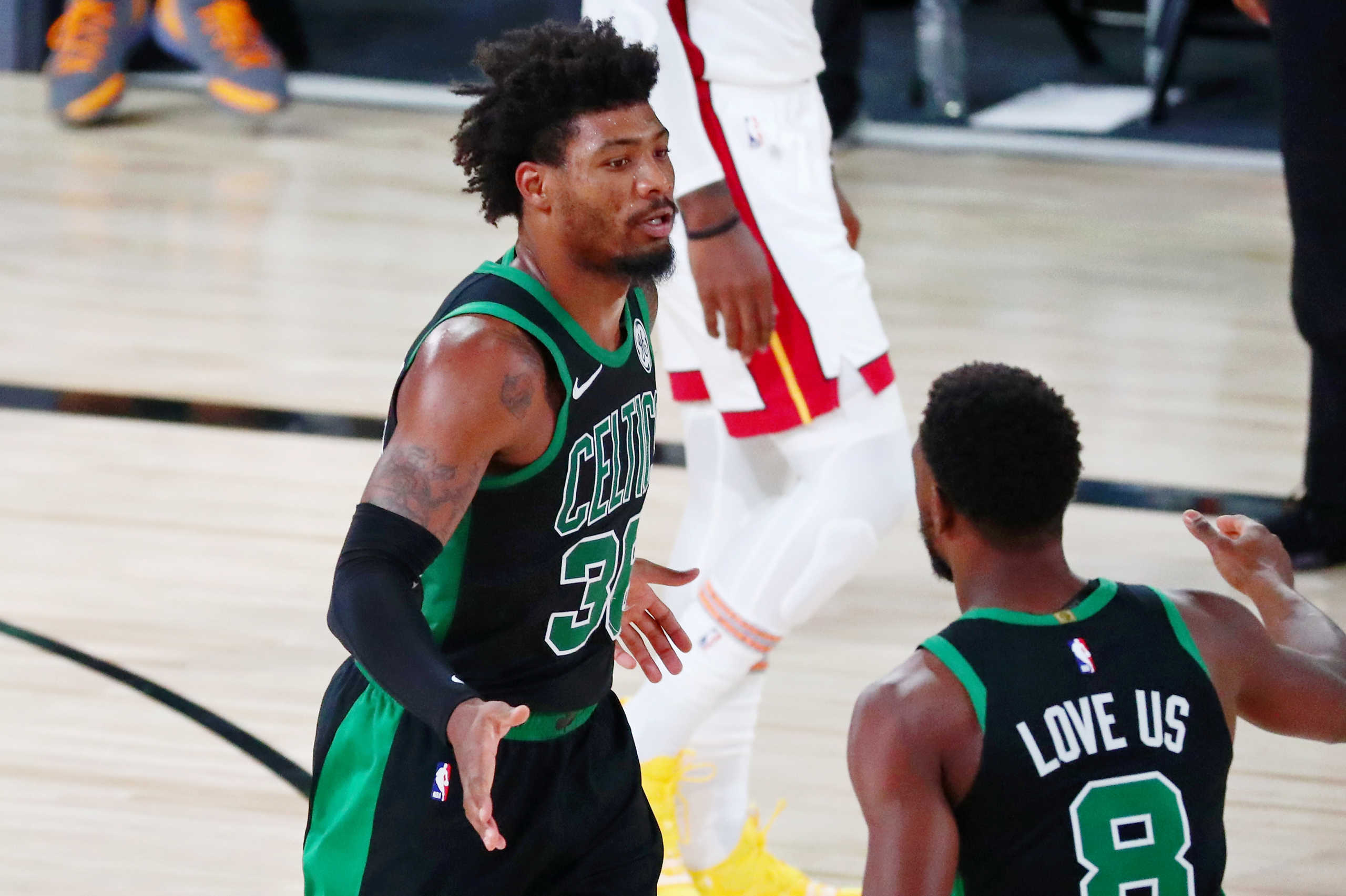 Sep 17, 2020; Lake Buena Vista, Florida, USA; Boston Celtics guard Marcus Smart (36) is congratulated by guard Kemba Walker (8) after a play against the Miami Heat during the second quarter in game two of the Eastern Conference Finals of the 2020 NBA Playoffs at ESPN Wide World of Sports Complex. Mandatory Credit: Kim Klement-USA TODAY Sports