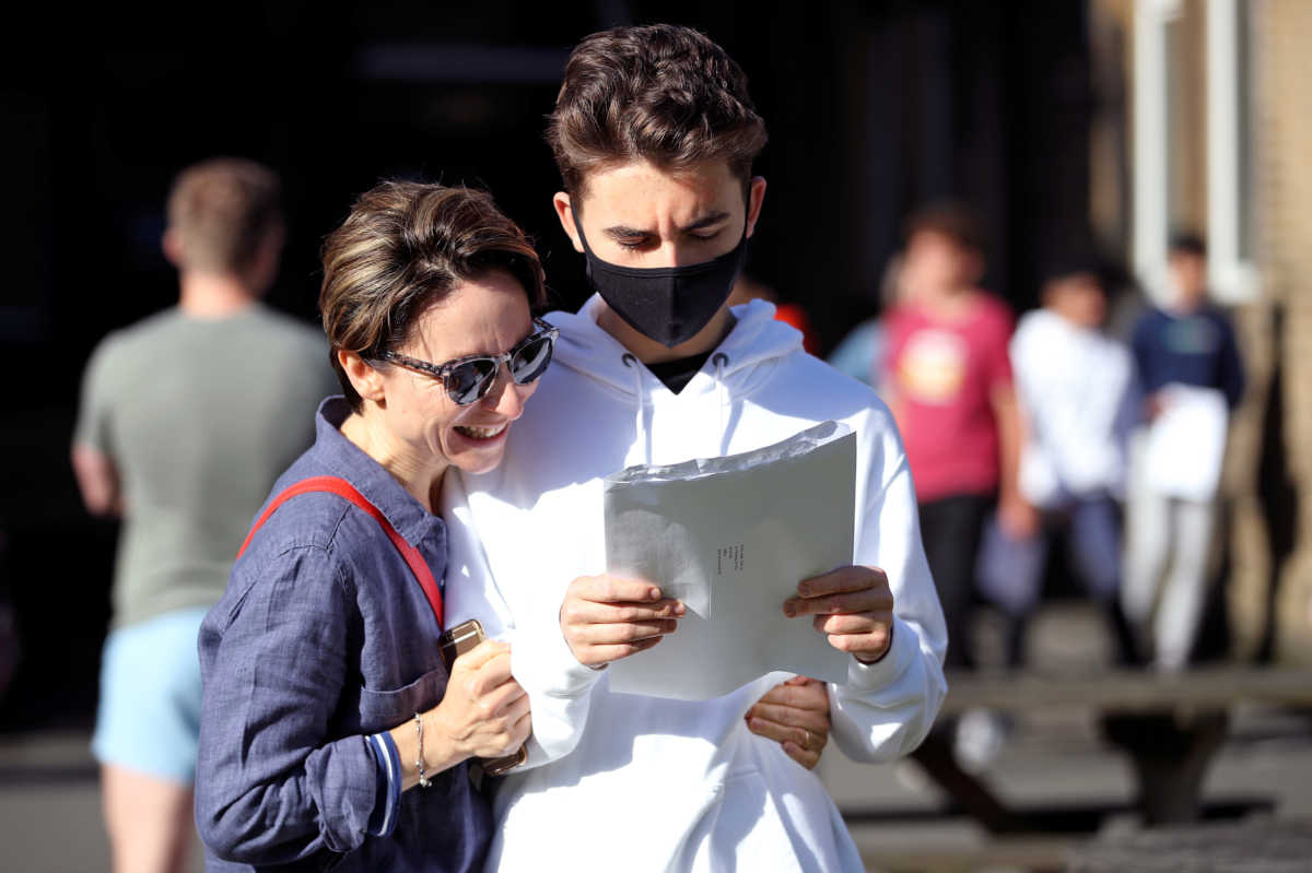A student checks his GCSE results at Crossley Heath Grammar School, amid the spread of the coronavirus disease (COVID-19), in Halifax, Britain August 20, 2020. REUTERS