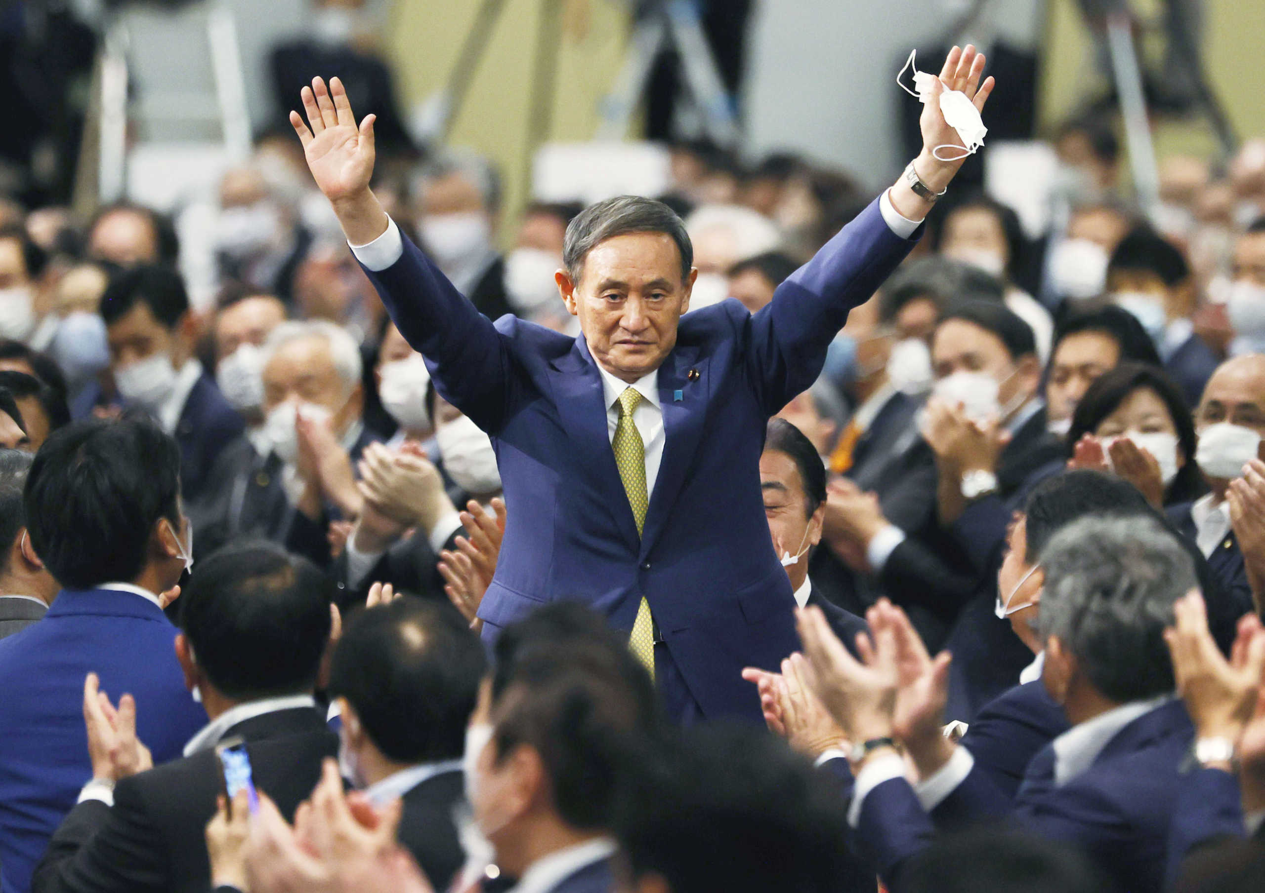 Japanese Chief Cabinet Secretary Yoshihide Suga gestures as he is elected as new head of the ruling party at the Liberal Democratic Party's (LDP) leadership election paving the way for him to replace Prime Minister Shinzo Abe, in Tokyo, Japan September 14, 2020 in this photo taken by Kyodo. Mandatory credit Kyodo via REUTERS ATTENTION EDITORS - THIS IMAGE WAS PROVIDED BY A THIRD PARTY. MANDATORY CREDIT. JAPAN OUT. NO COMMERCIAL OR EDITORIAL SALES IN JAPAN.
