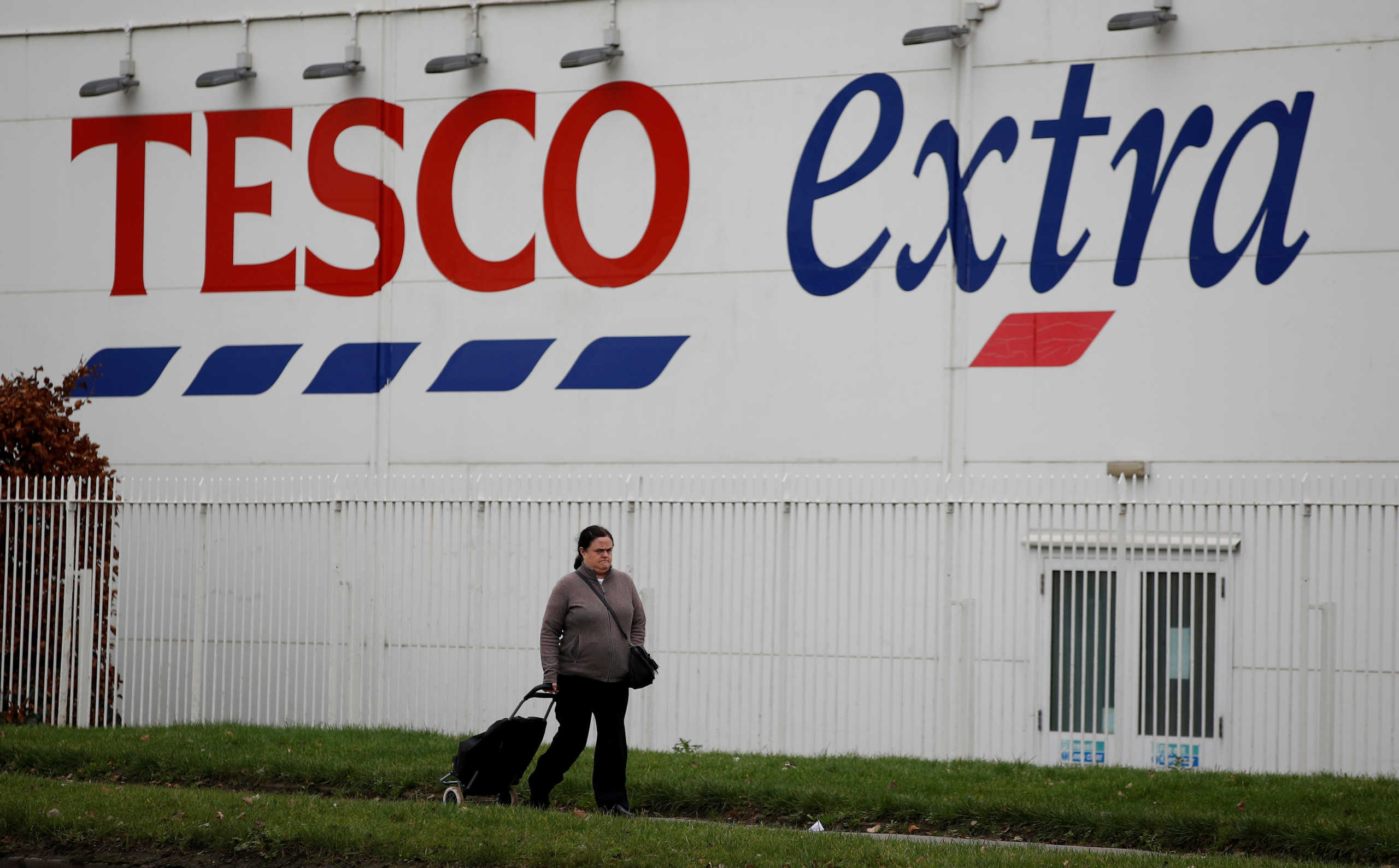 FILE PHOTO: A woman walks past a Tesco extra superstore near Manchester, Britain January 8, 2020. REUTERS