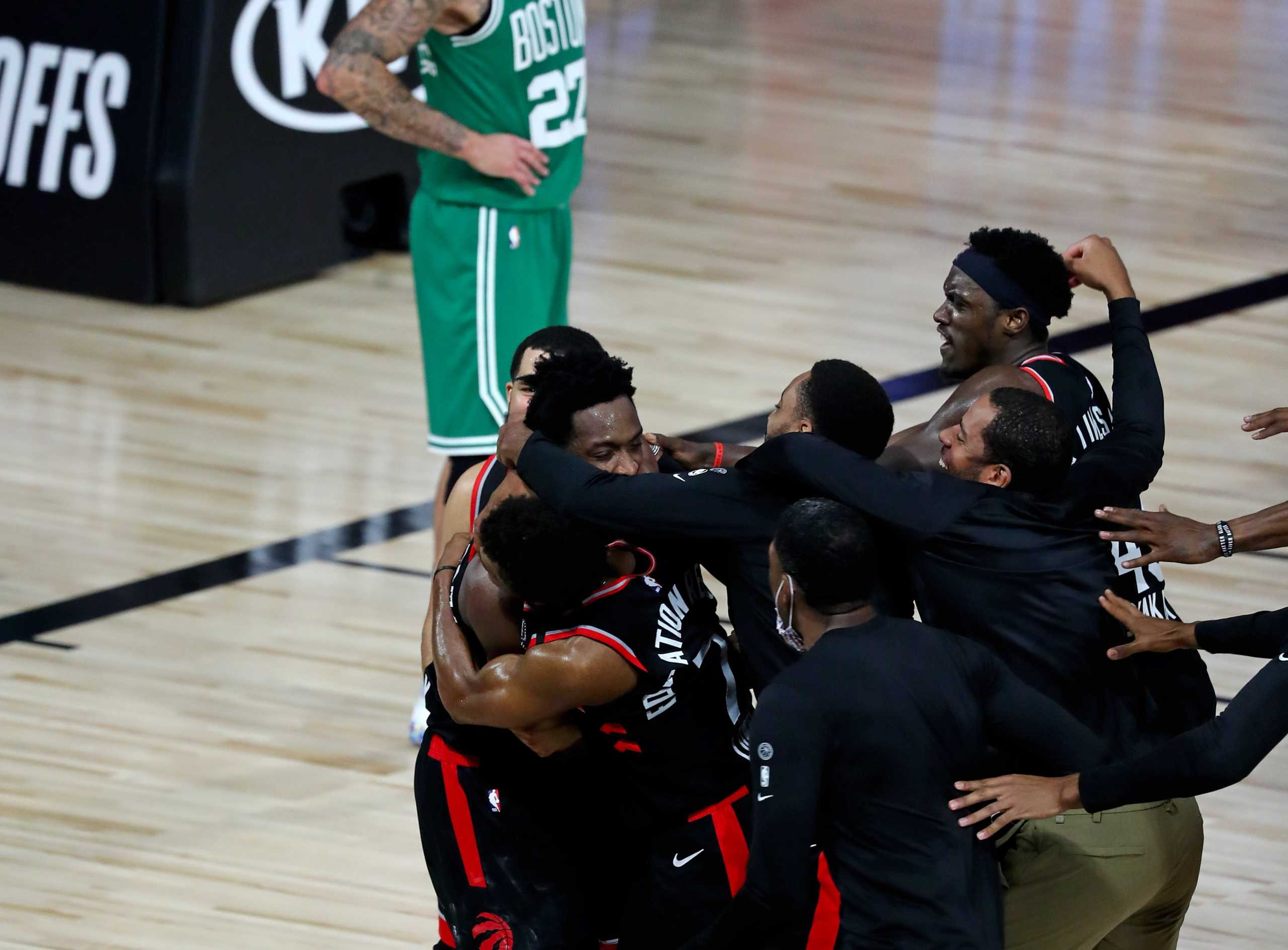 Sep 3, 2020; Lake Buena Vista, Florida, USA; Toronto Raptors forward OG Anunoby (3) is mobbed by teammates after making the game winning three point basket to defeat the against the Boston Celtics in game three of the second round of the 2020 NBA Playoffs at ESPN Wide World of Sports Complex. Mandatory Credit: Kim Klement-USA TODAY Sports