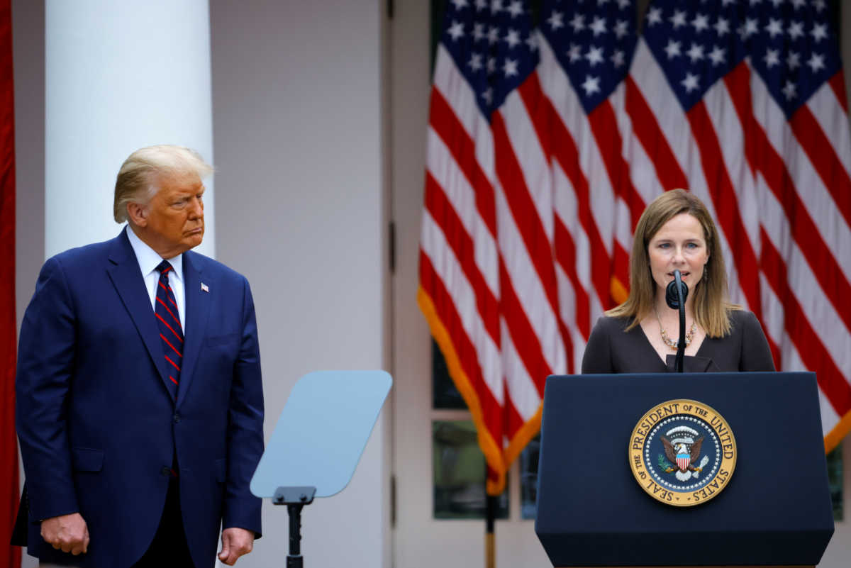 U.S President Donald Trump watches U.S. Court of Appeals for the Seventh Circuit Judge Amy Coney Barrett deliver remarks as he holds an event to announce her as his nominee to fill the Supreme Court seat left vacant by the death of Justice Ruth Bader Ginsburg, who died on September 18, at the White House in Washington, U.S., September 26, 2020. REUTERS