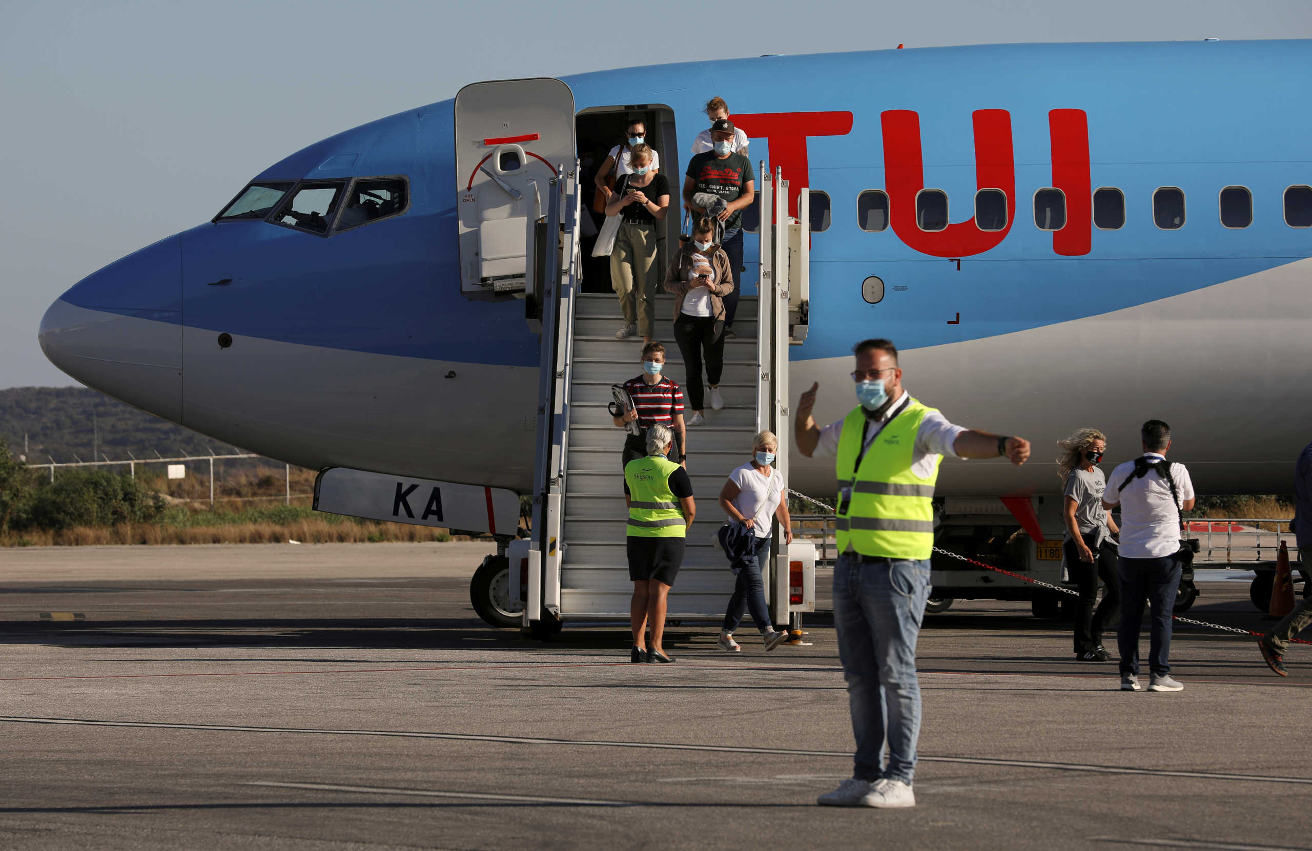 FILE PHOTO: Passengers from Germany, who were frontline workers during the coronavirus disease (COVID-19) outbreak, arrive on a TUI Airways flight at Kos International Airport on the island of Kos, Greece, June 29, 2020. REUTERS