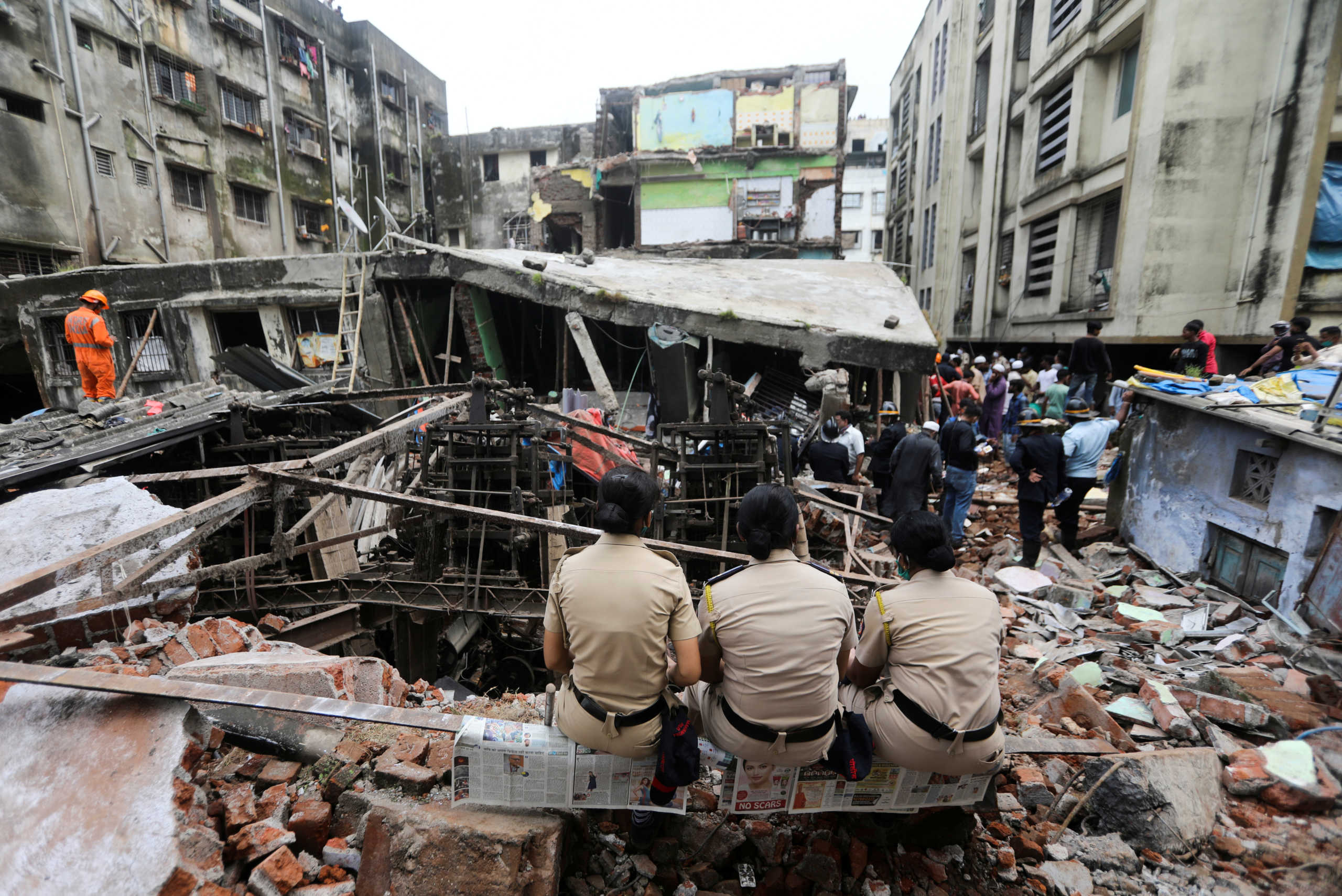 FILE PHOTO: Police officers watch rescue operations after a three-storey building collapsed in Bhiwandi, on the outskirts of Mumbai, India, September, 21 2020. REUTERS